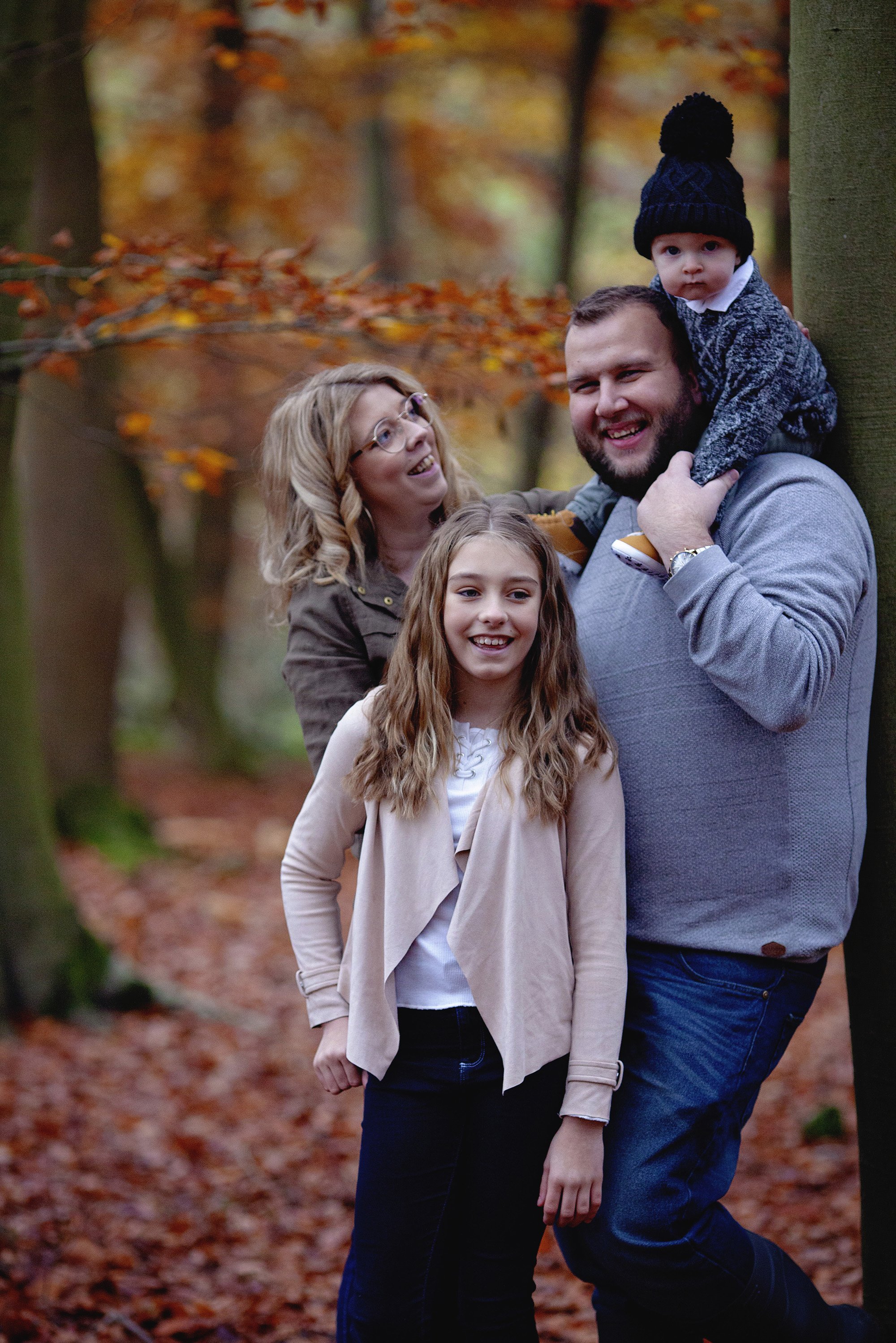 Family posed in Autumn leaves