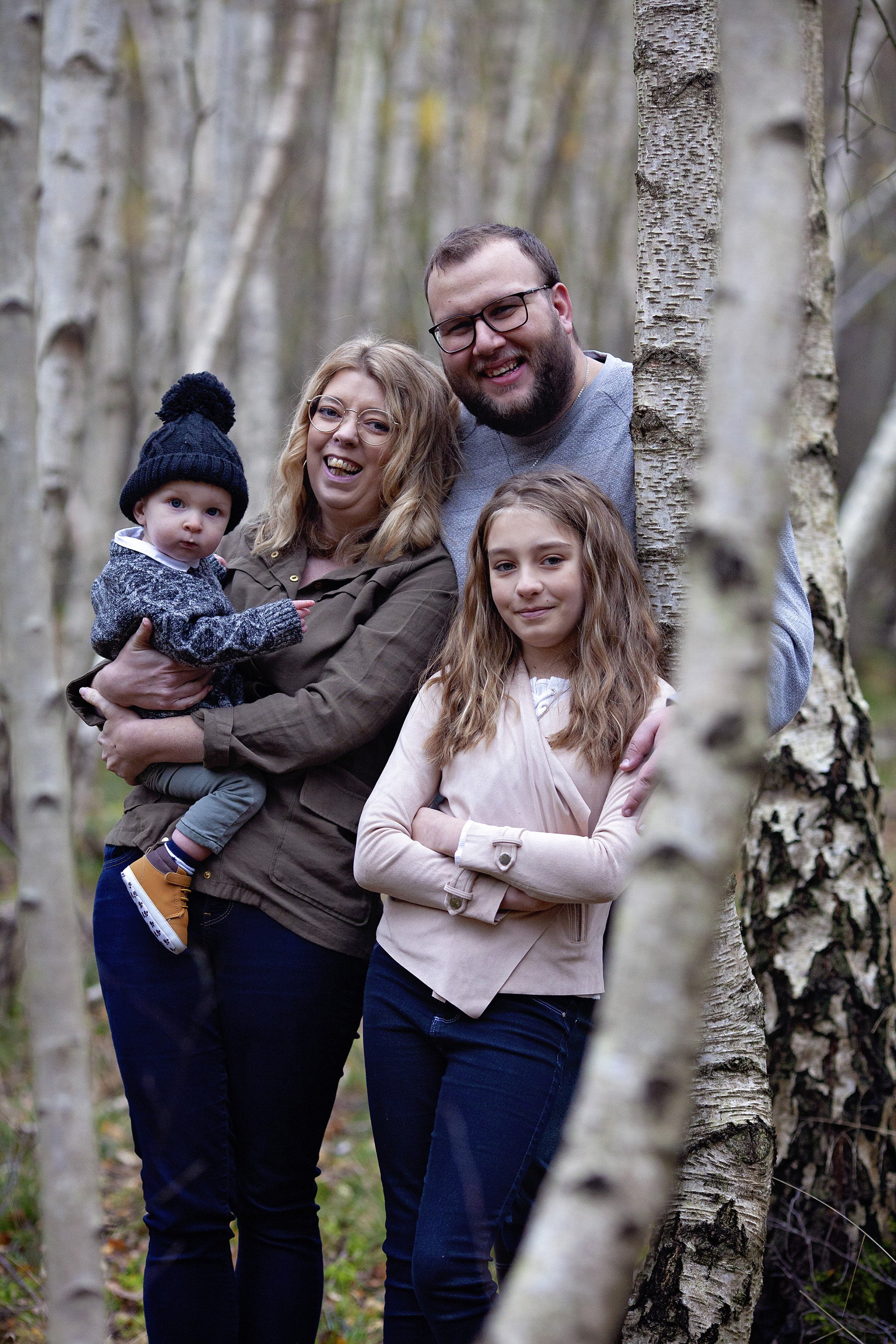Family posing in Silver birch trees