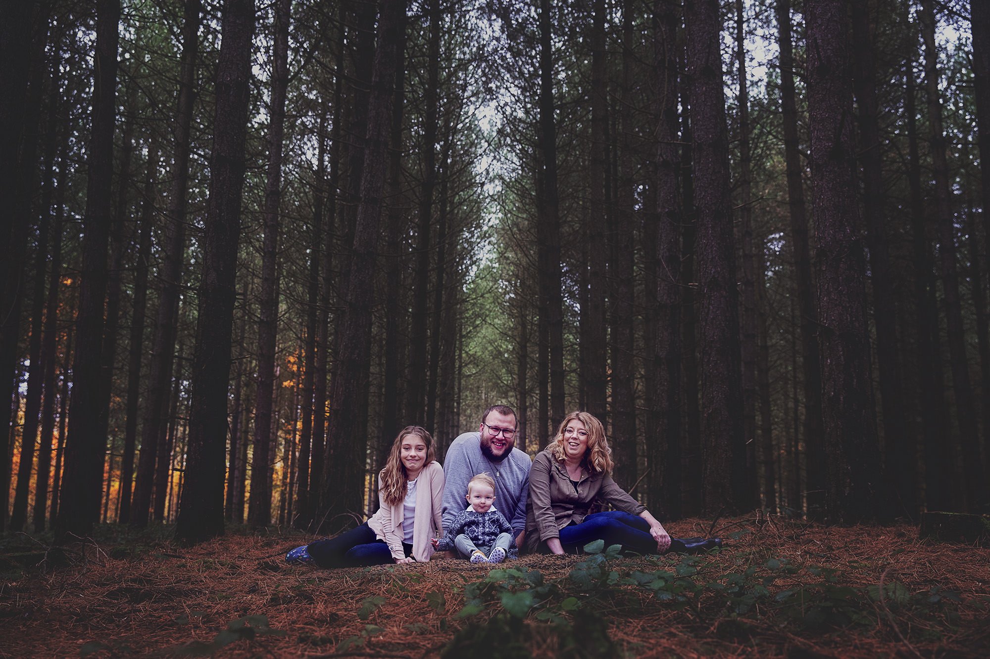 Posing family in conifer woods photoshoot