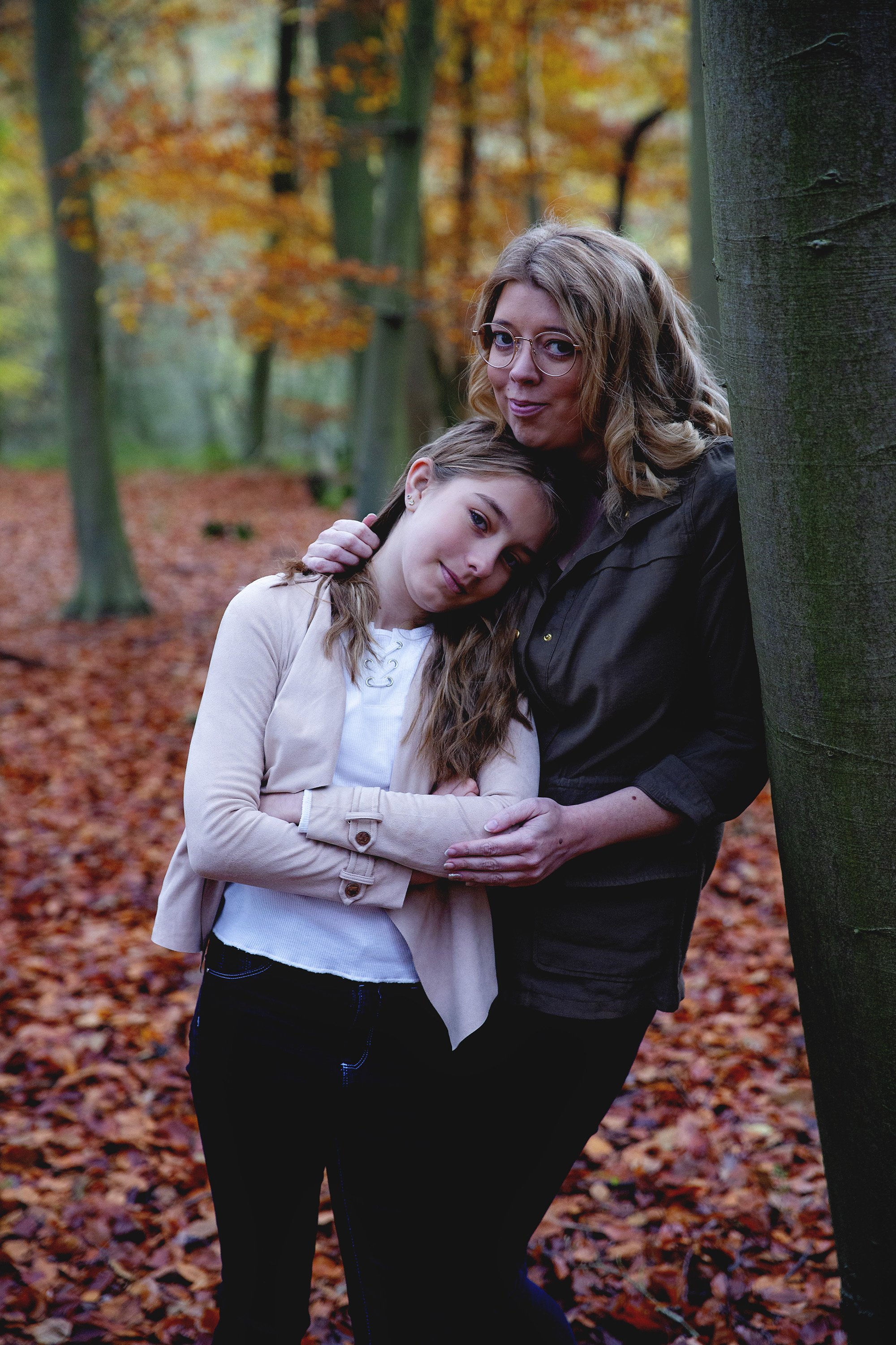 Mum and daughter in Autumn leaves