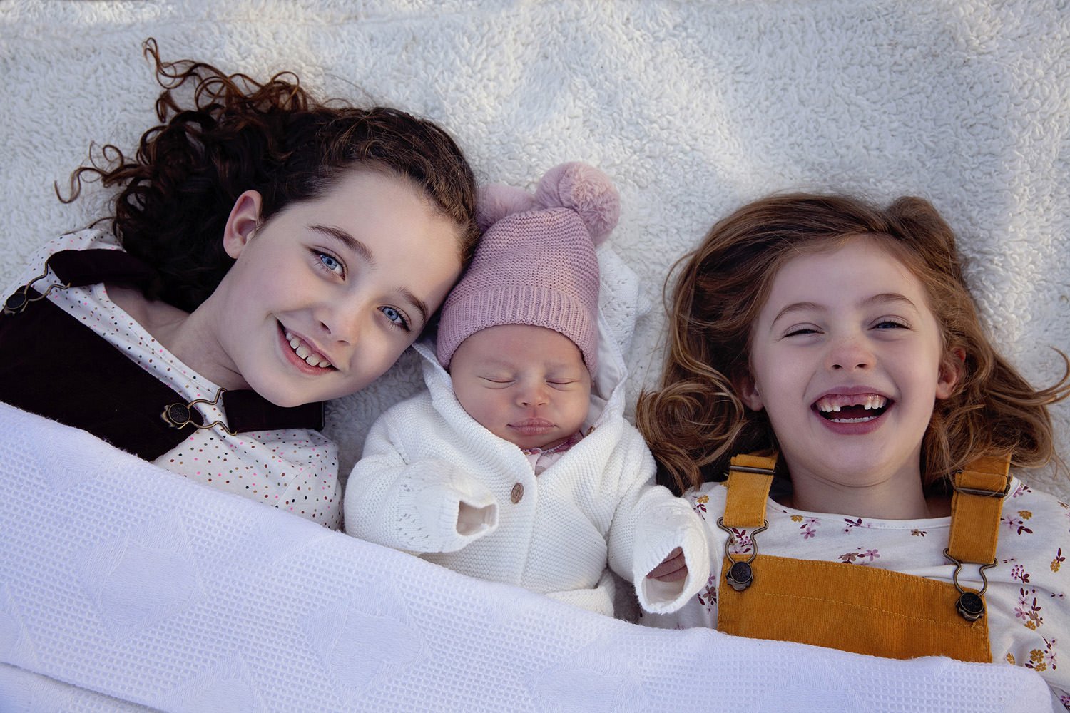 2 sisters with their baby sister