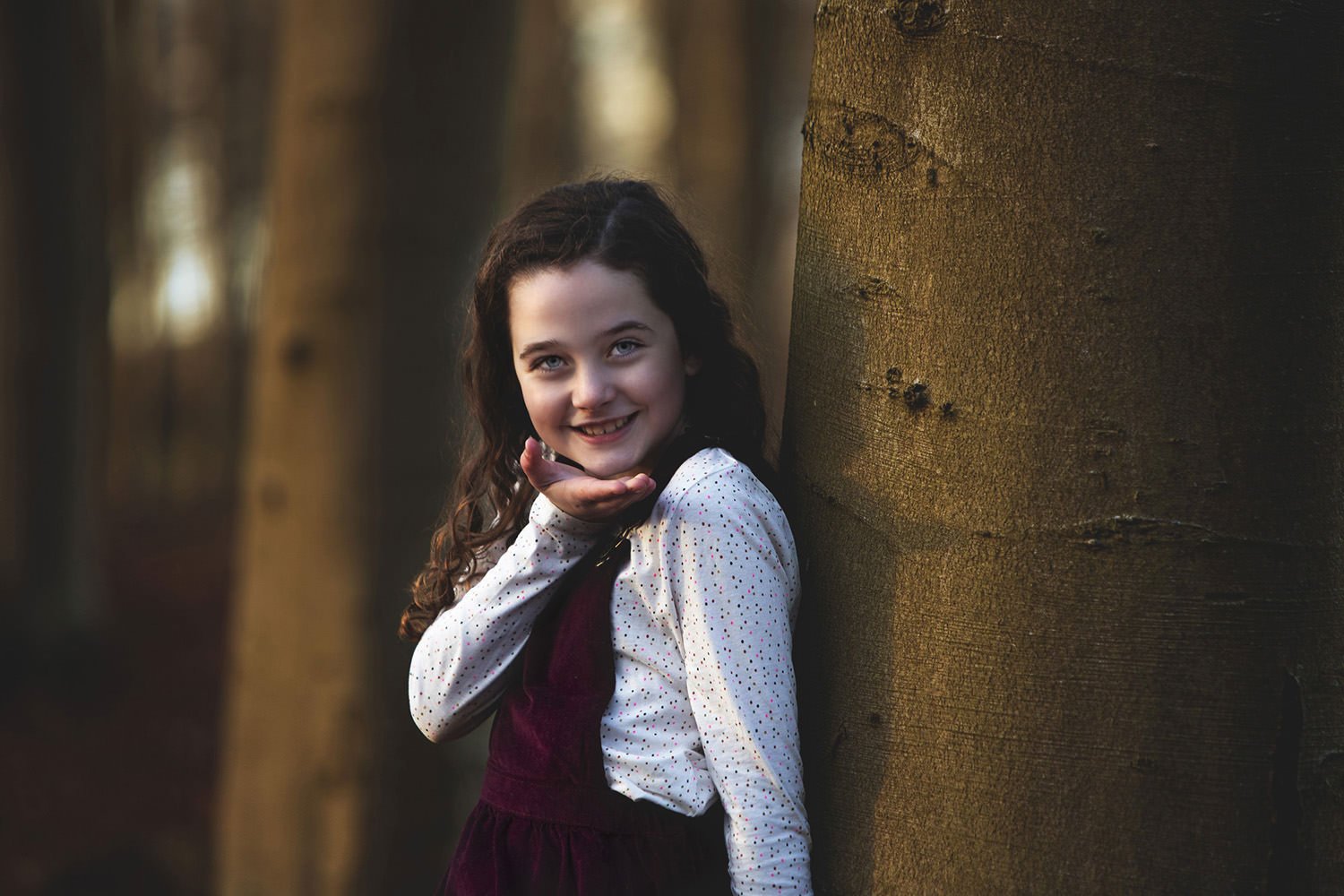 Girl blowing kisses on winter family photoshoot