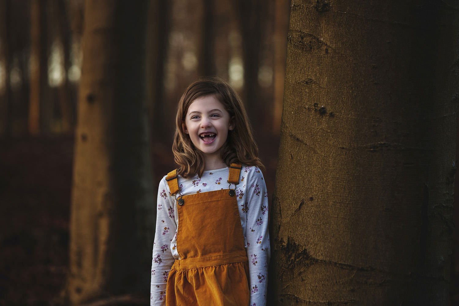 Girl in dungarees laughing