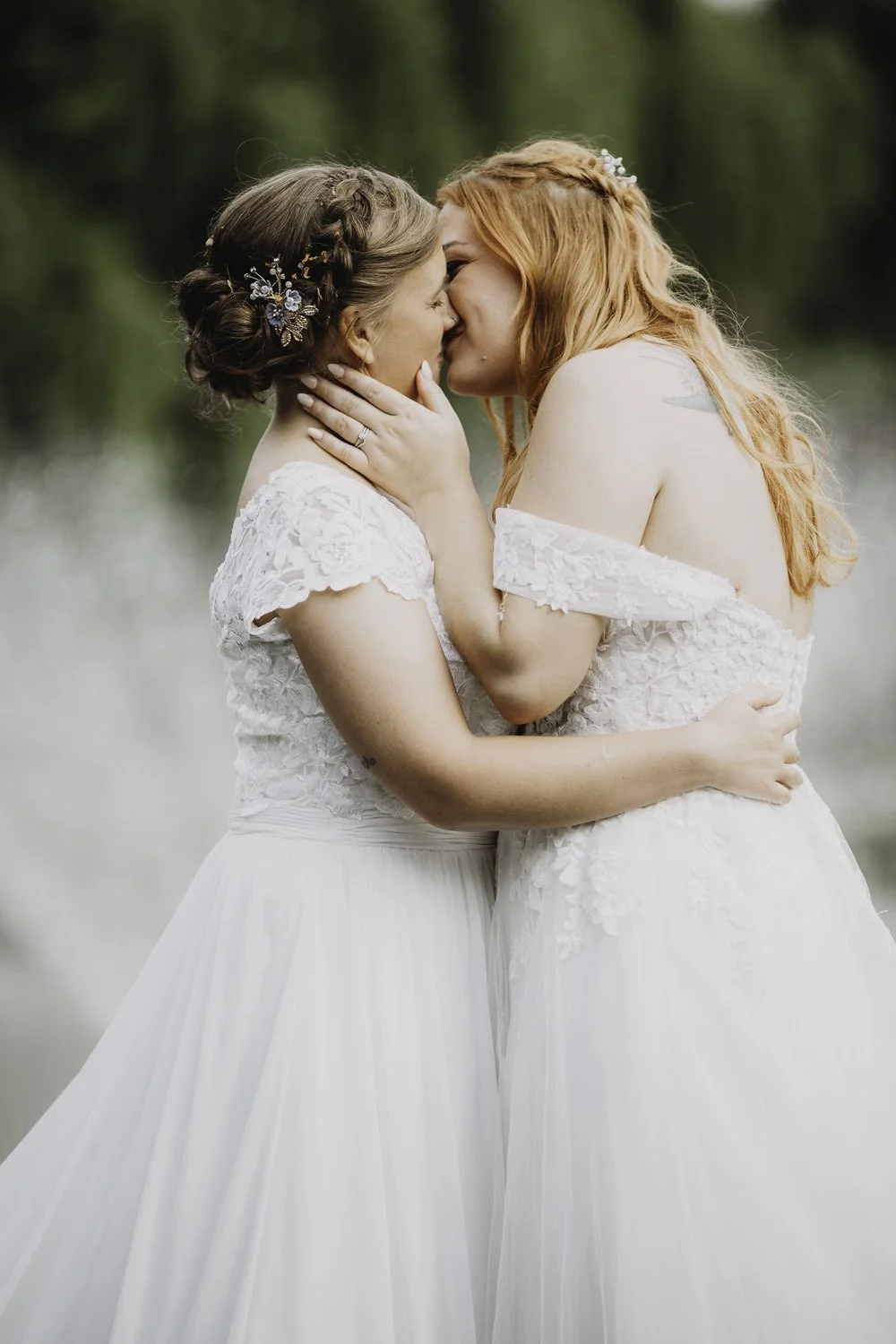 Two brides kissing