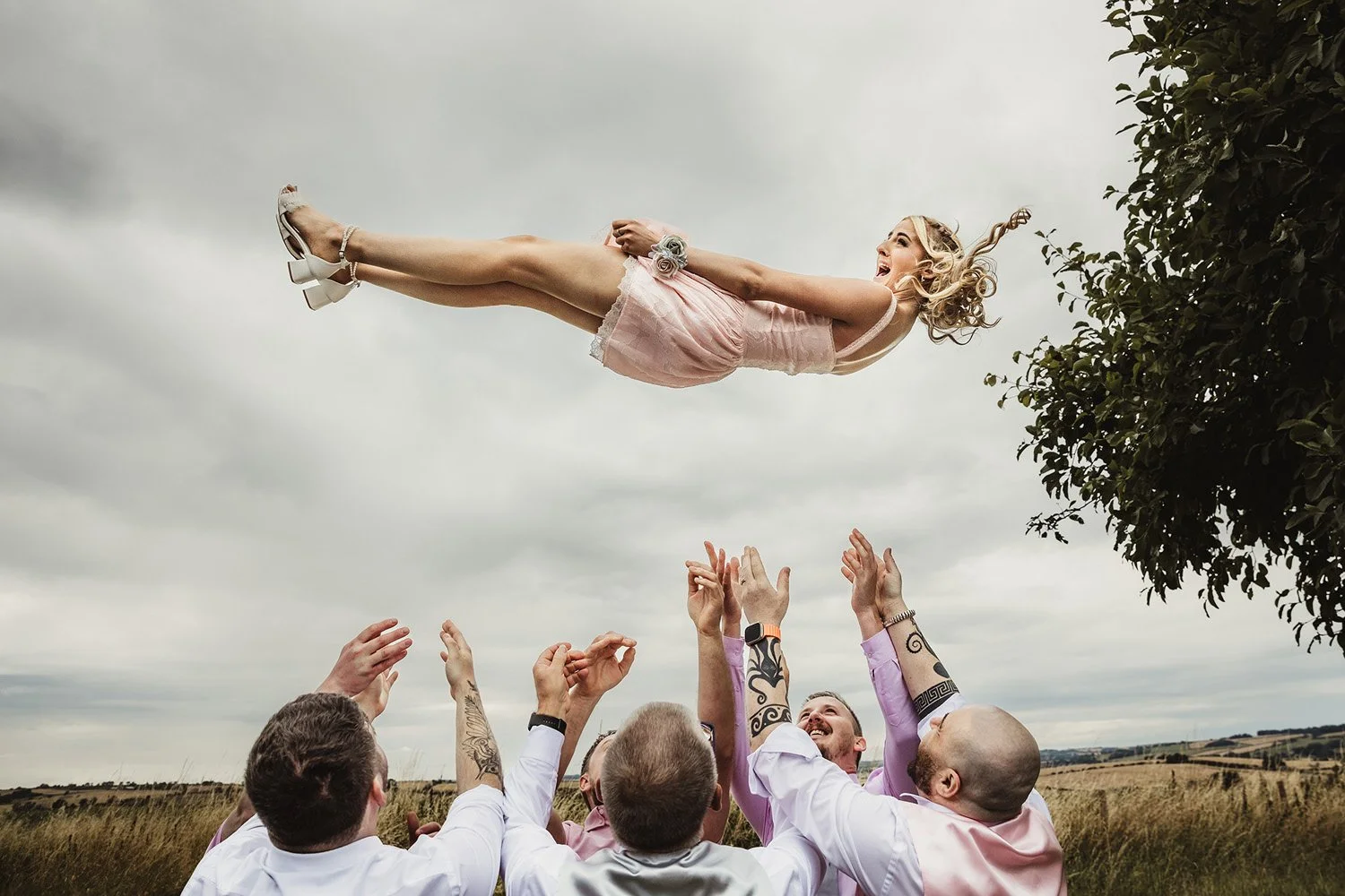bridesmaid being thrown in the air