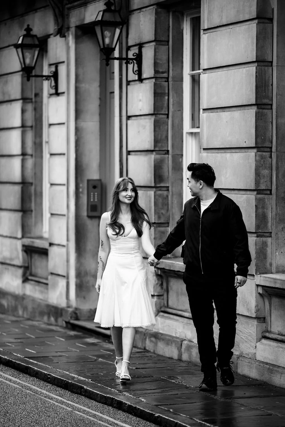 Engaged couple walking through the streets of Stamford.