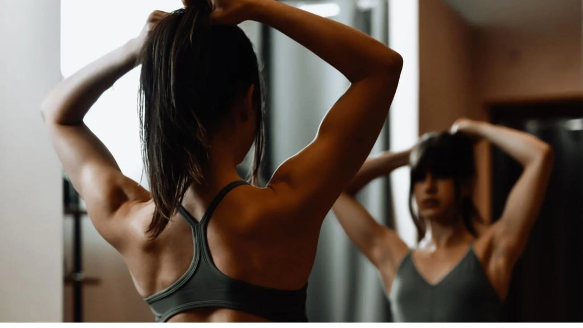 brushing hair extensions up for a ponytail ready for gym.