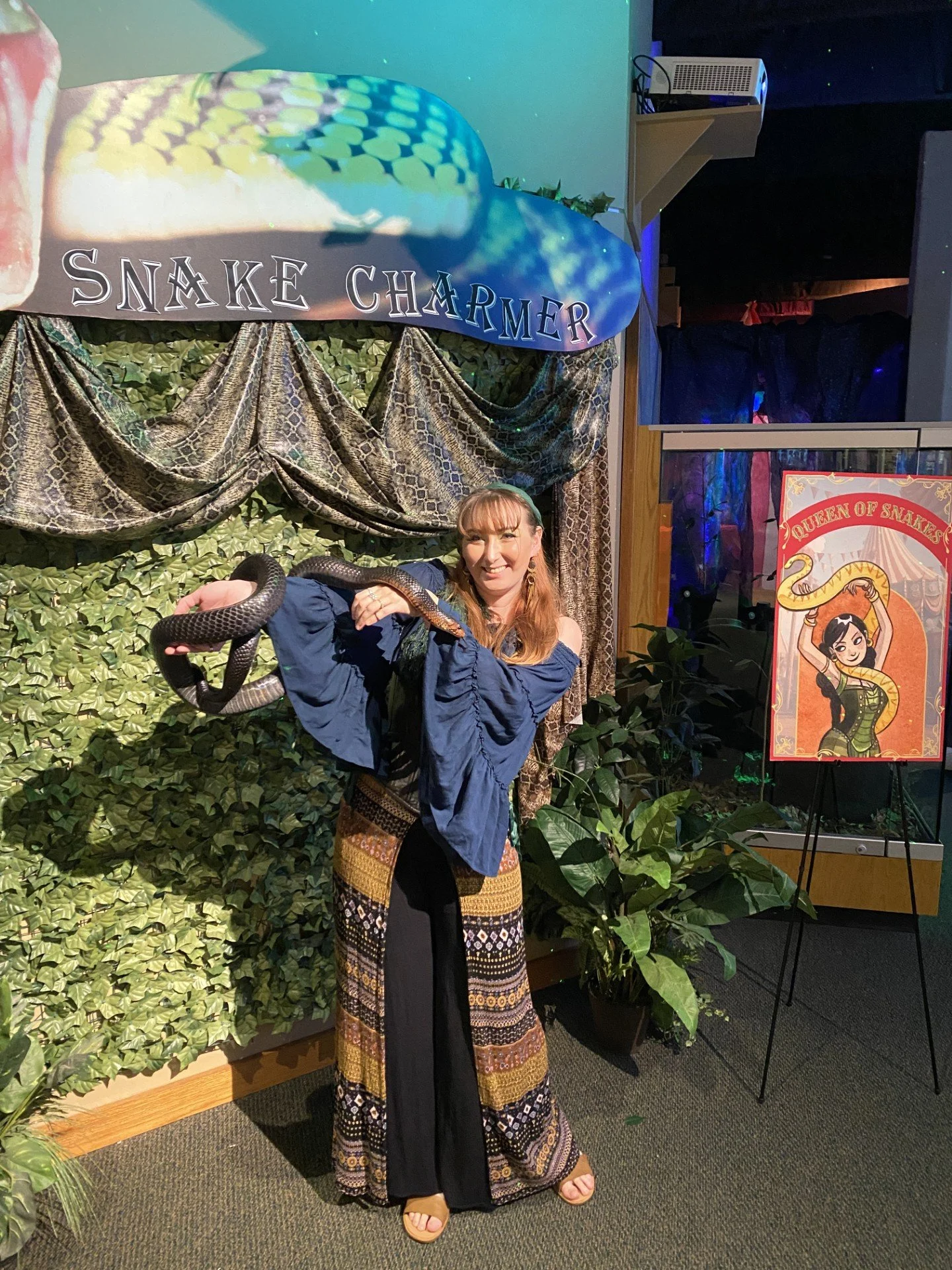 Gabi Guest with a snake at Park After Dark Halloween event
