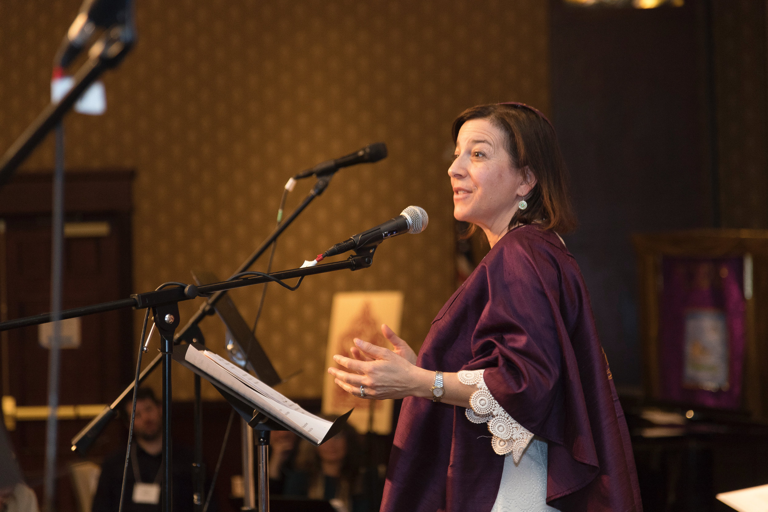 Rabbi Amy Grossblatt Pessah Speaking into Microphone