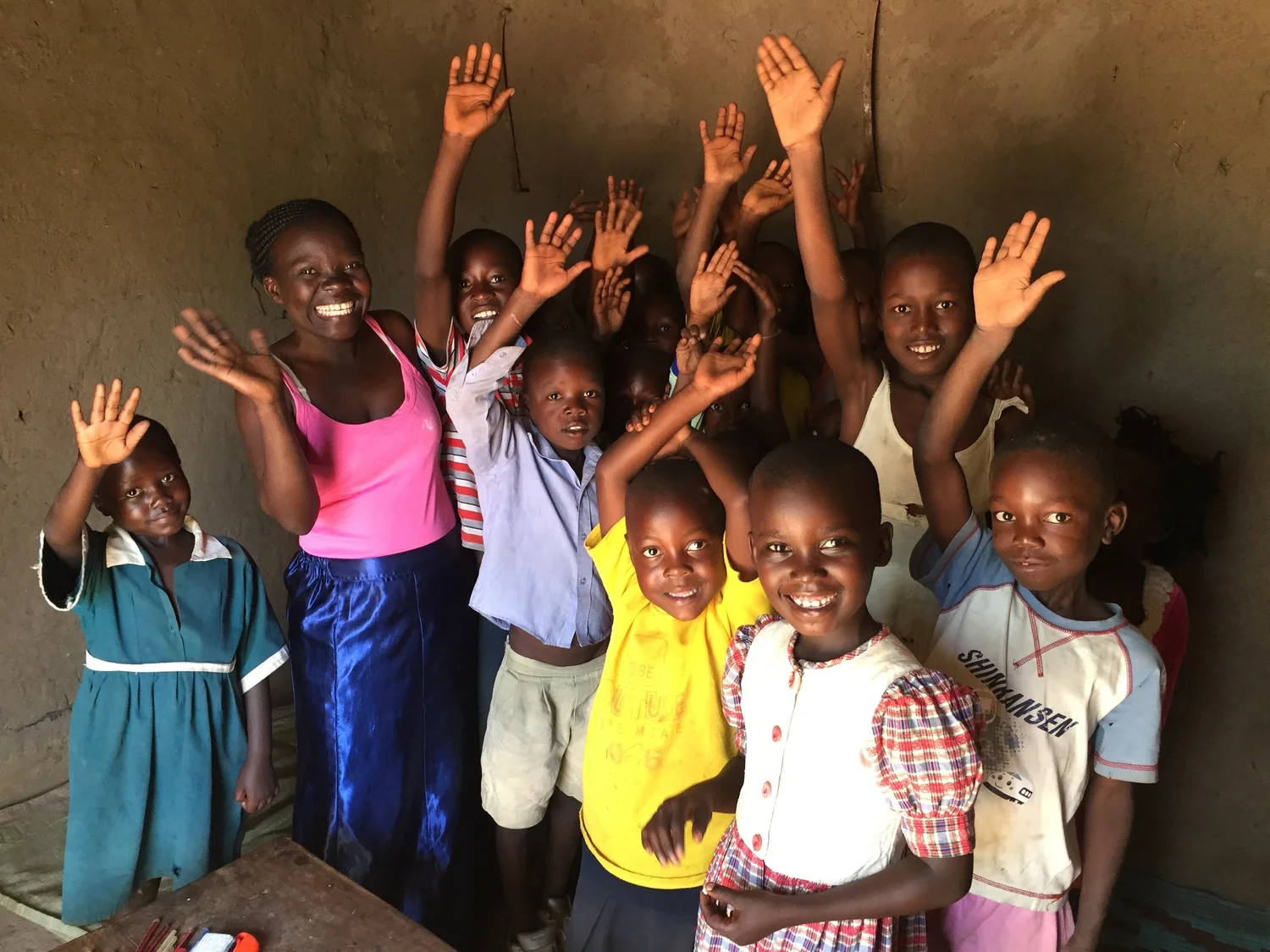 Children in Uganda waving at the camera