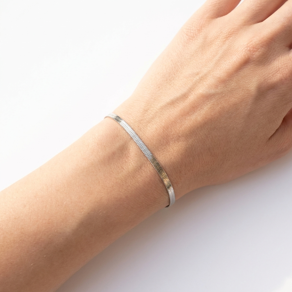 Wrist wearing slim silver flat herringbone stainless steel bracelet - minimal waterproof jewellery - Kincha Designs London