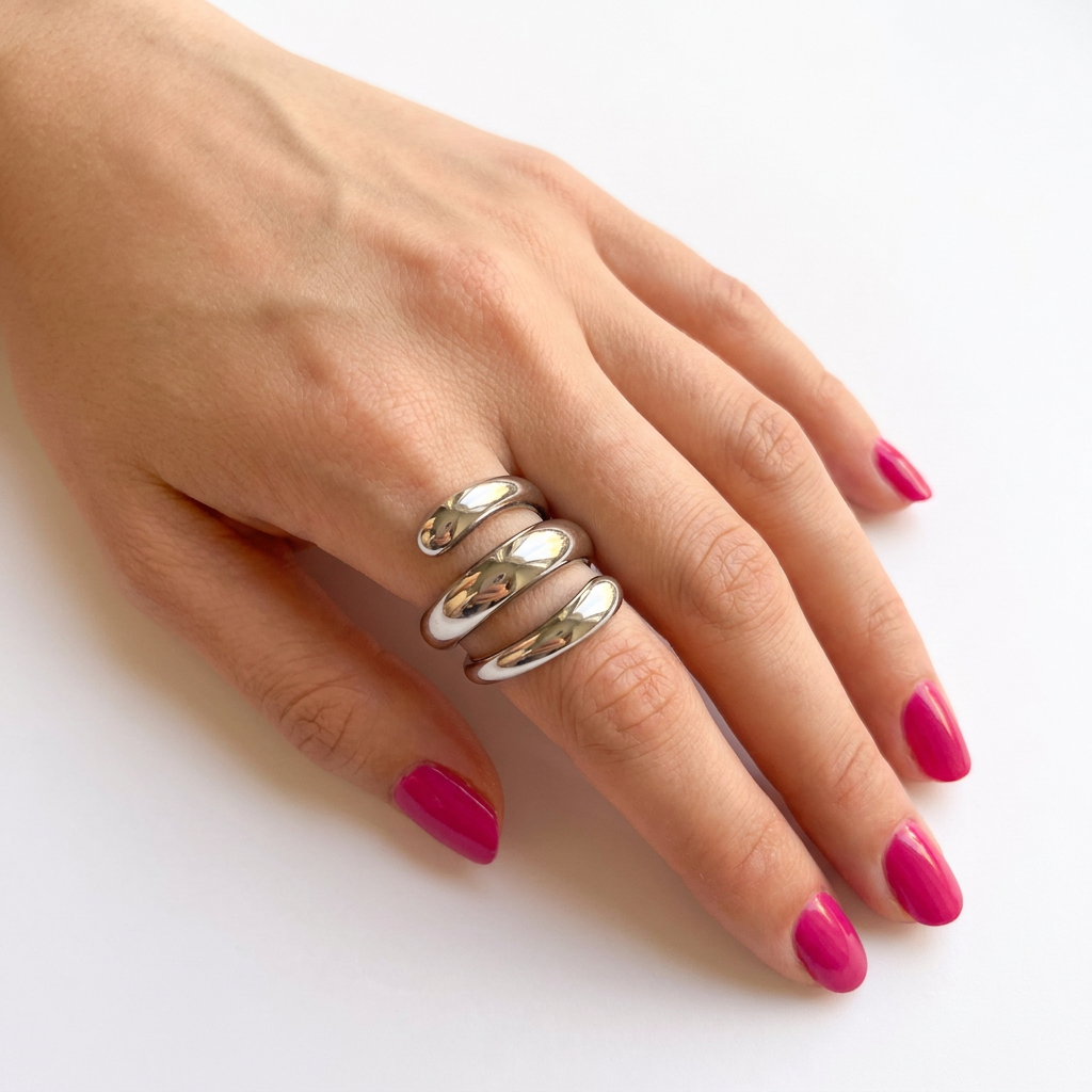 Hand wearing silver triple coil stainless steel ring with pink nails - Kincha Designs London