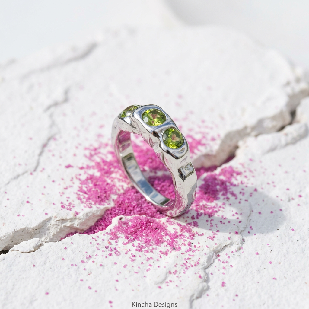 Green crystal stainless steel ring on pink sand background - waterproof jewellery London - Kincha Designs