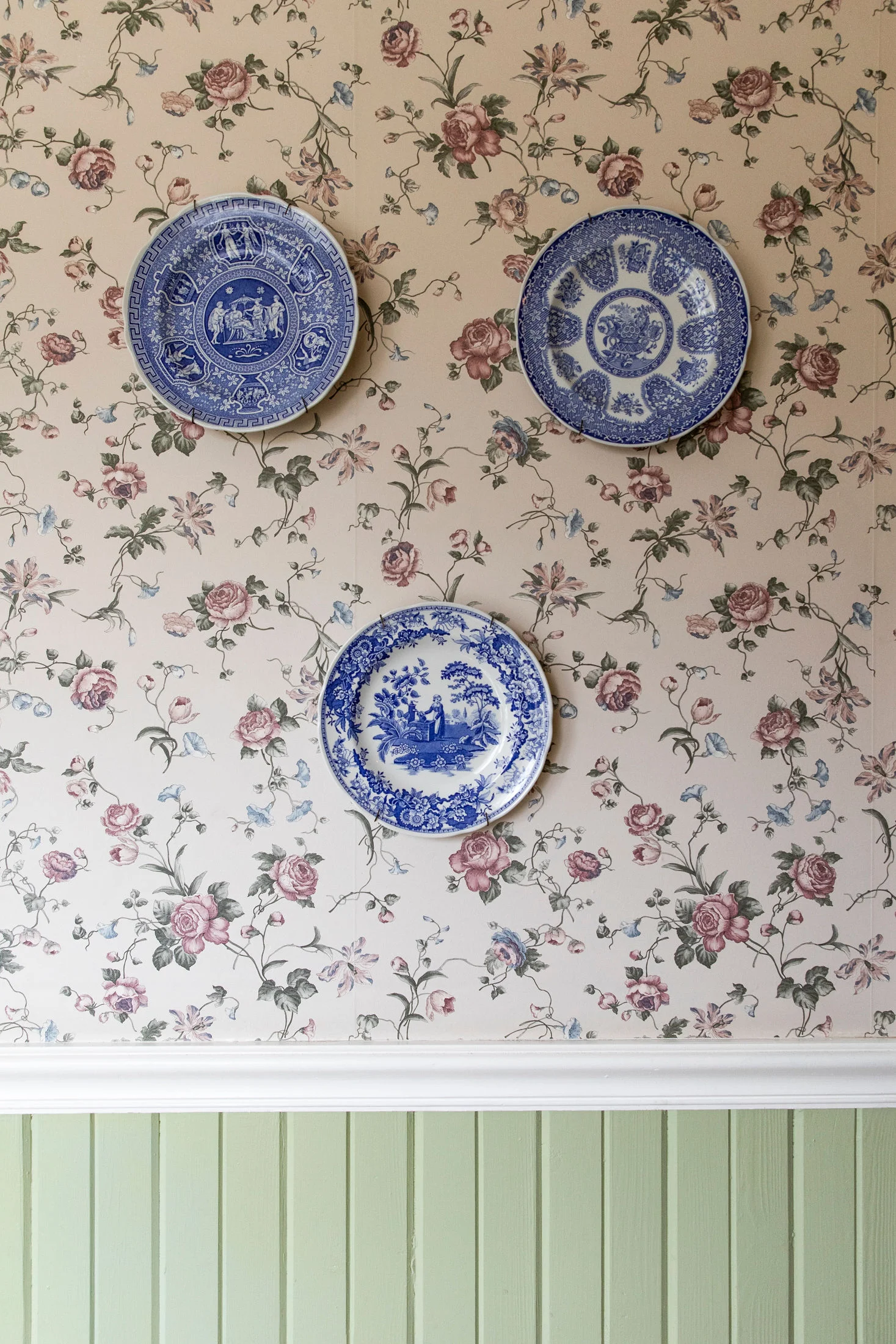 A trio of vintage plates hang on the wall at the Headlands Inn, a Bed & Breakfast in Mendocino, CA