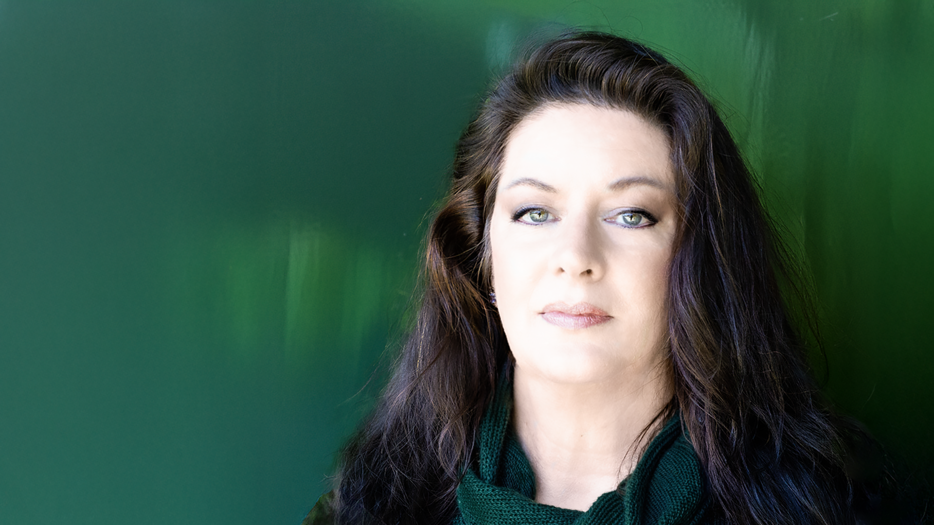 On a dark green background, a portrait of award-winning author Catherine Wallace Hope
