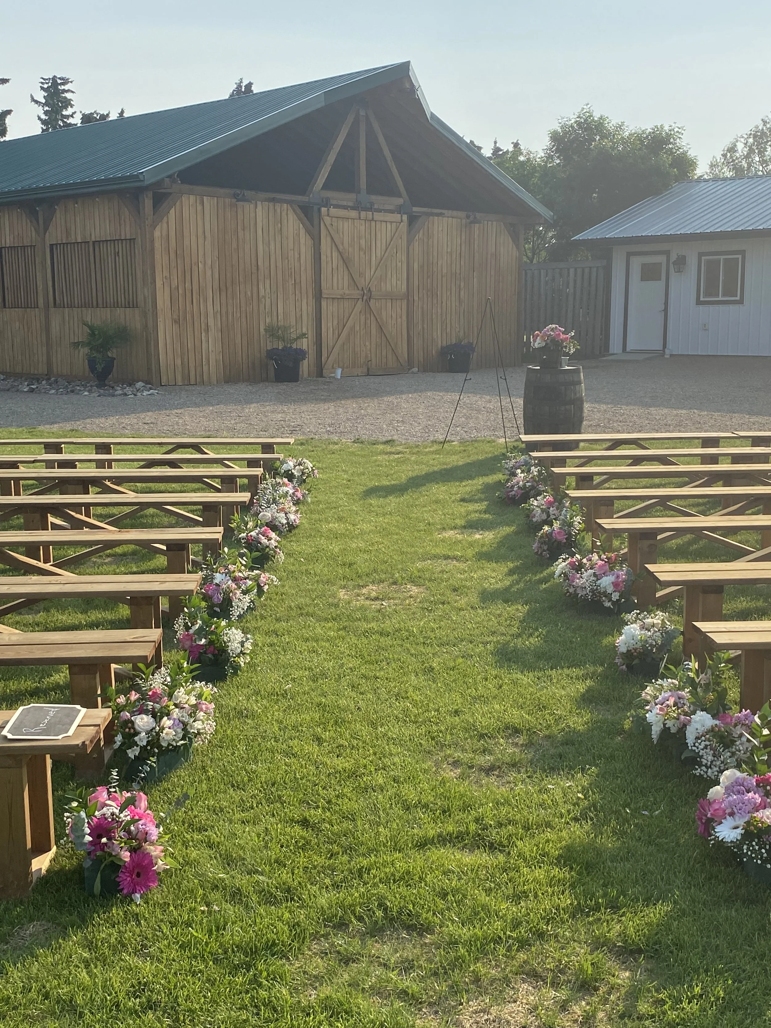 flower lined aisle with recption build in back.JPG