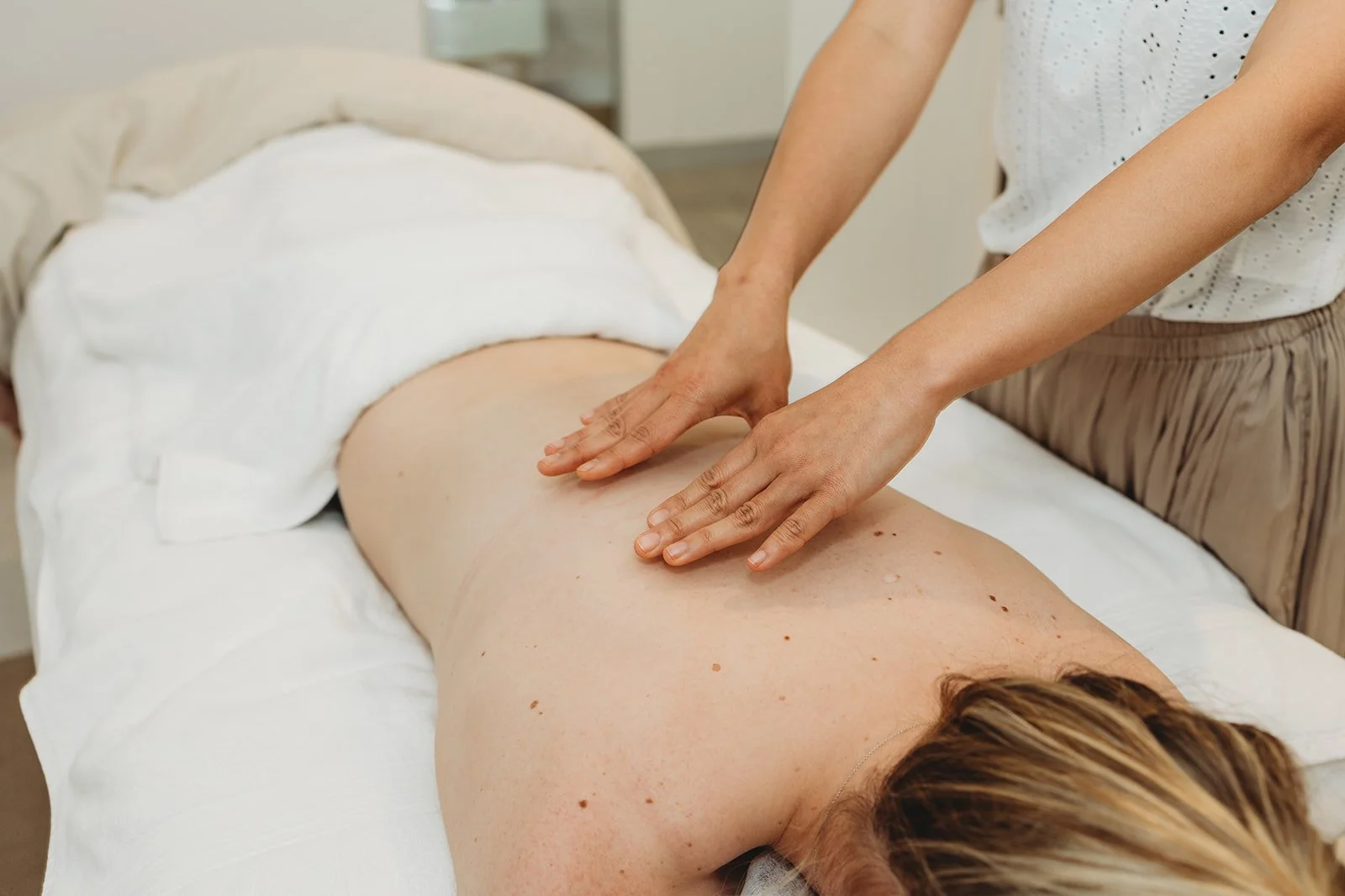 A person is receiving a massage on their back in the Maternal and Infant Wellbeing Melbourne day spa.