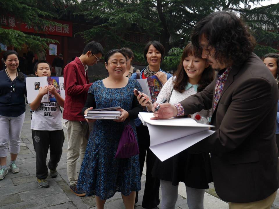  Zhu Hong signing art catalogues at the Beijing Art Museum in 2013 