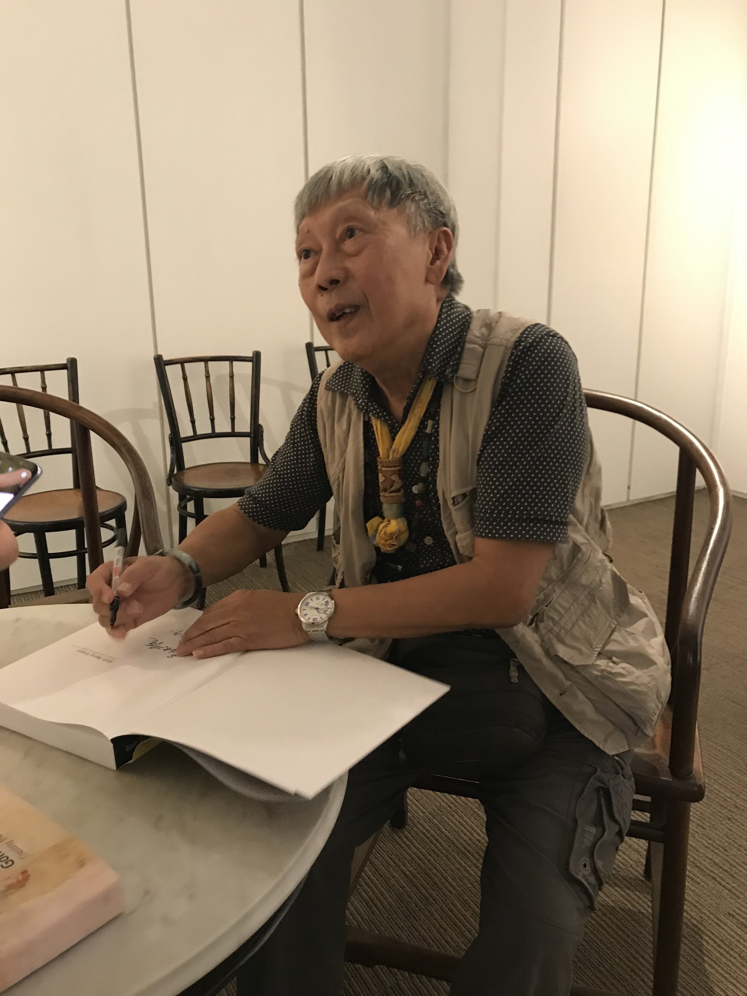  Mr Goh Beng Kwan signing his art catalogue during hi solo exhibition in 2019 