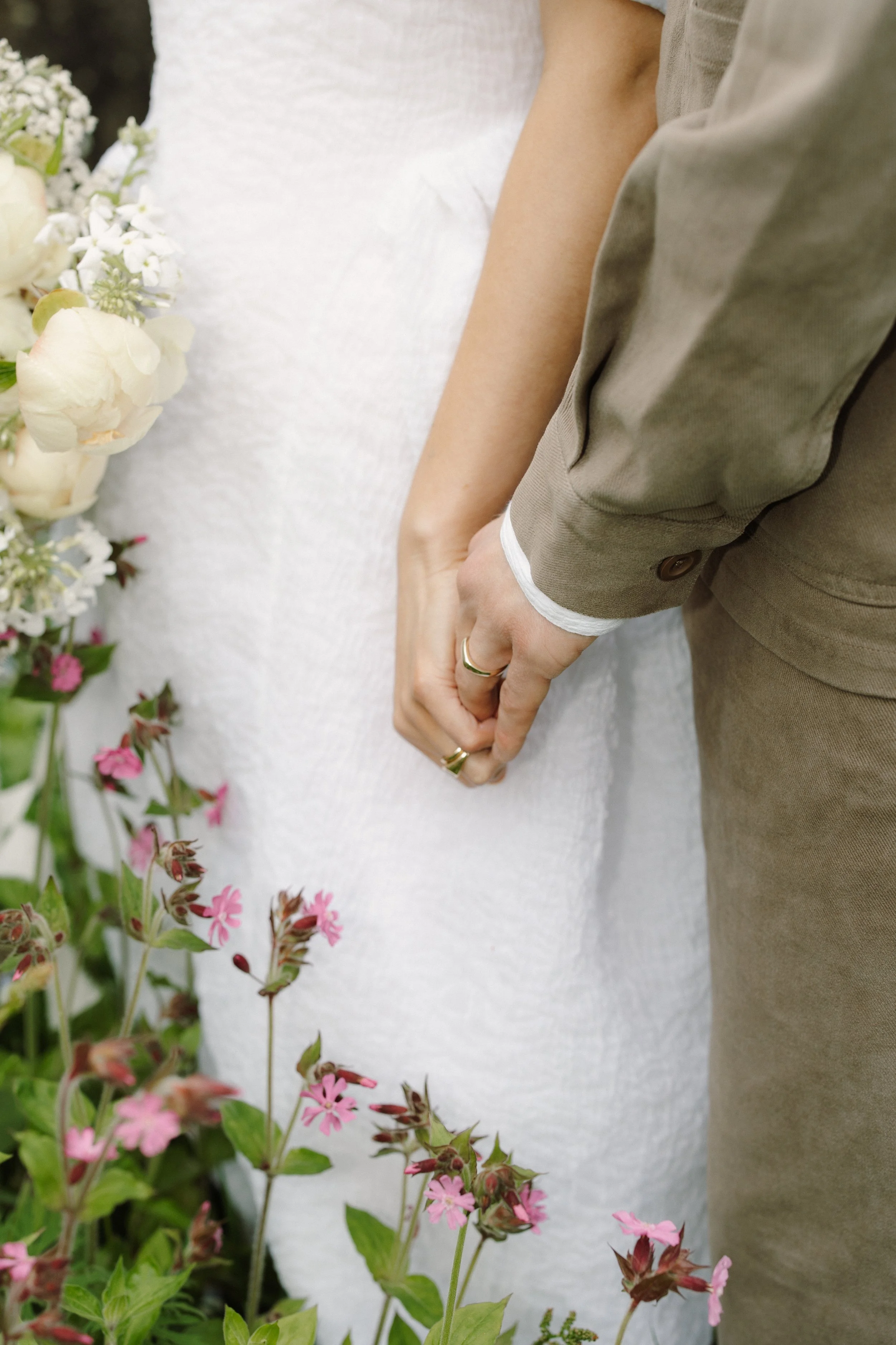 Bride wearing Cecilie Bahnsen holding a bouquet by honour farm flowers, florist in west yorkshire.