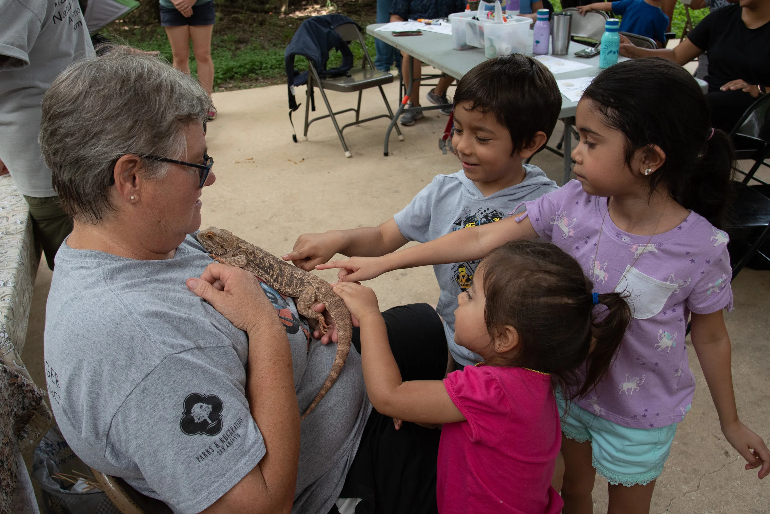Children get to touch a bearded dragon at the Growing Up Wild class.