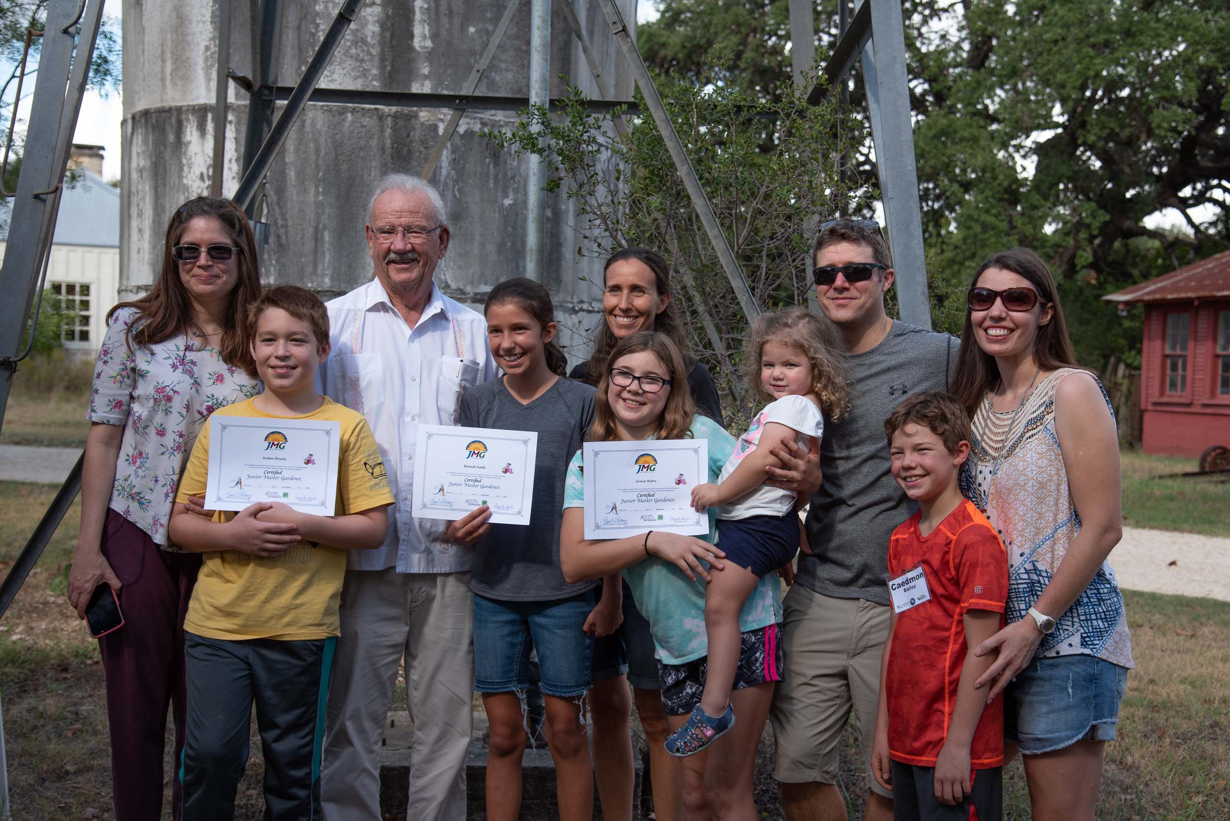  Former San Antonio Mayor and park namesake, Phil Hardberger (third from the left) stands with the three Junior Master Gardeners and their families.  