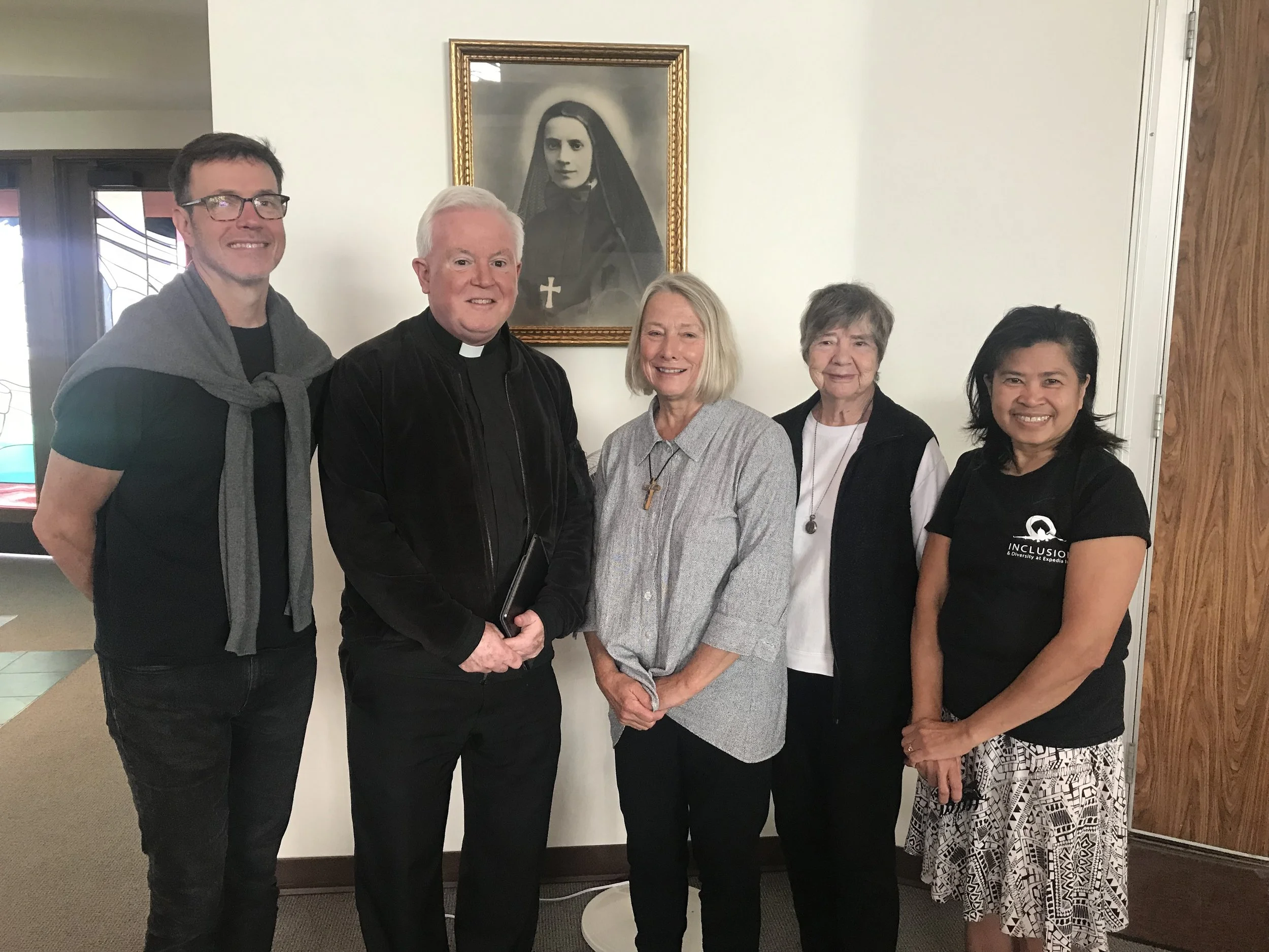 Pictured: Angus McDonald in training for Camillus lay ministry. Fr. William Heric, Joyce “Jake “ Jacobs, Camillus minister and coordinator for St Bridget and Seattle Children’s, Theresa Lavallee, Camillus minister and Marissa Herrmannsfeldt, Camillus minister. Photo taken July 19, 2019 at St Bridget. Mother Cabrini in photo.