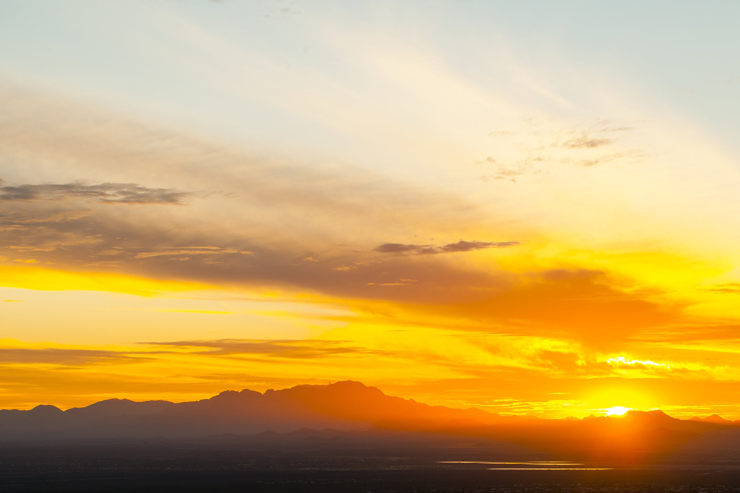 Golden sunrise over distant mountains, symbolizing hope, renewal, and the quiet invitation to begin the day in prayer.