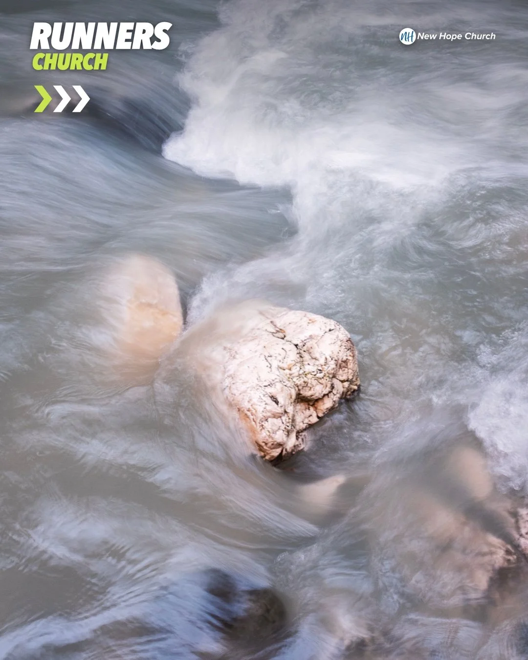 Long-exposure photograph of river water blurring past sharp, unmoving rocks