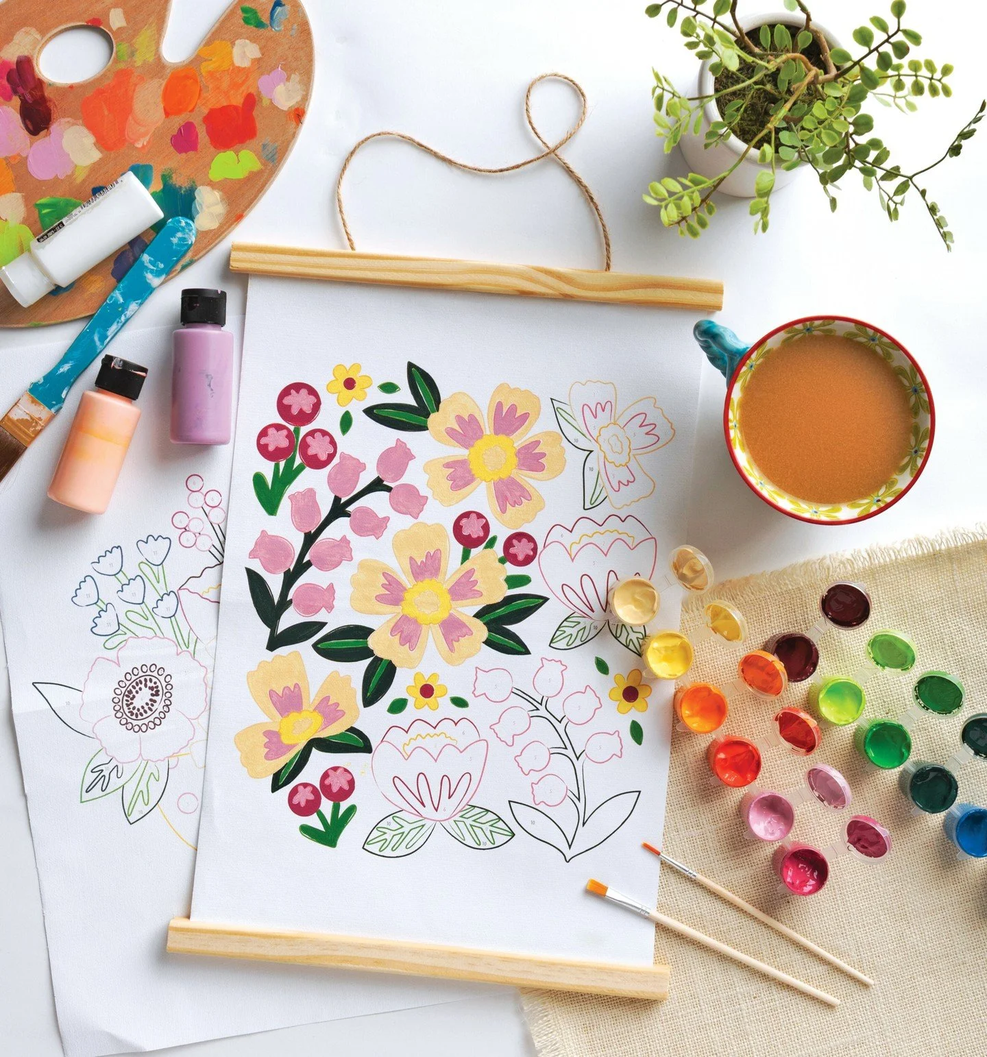 Sneak Peek! 🖌️ COLORMAPS PAINT-BY-NUMBER KITS by OLIVIA GIBBS of @oliviagibbsillustration are launching in just a few days! Here's a sneak peek of everything that's included in each kit&mdash;3 canvases, 12 acrylic paint pots, a magnetic frame, 2 pa