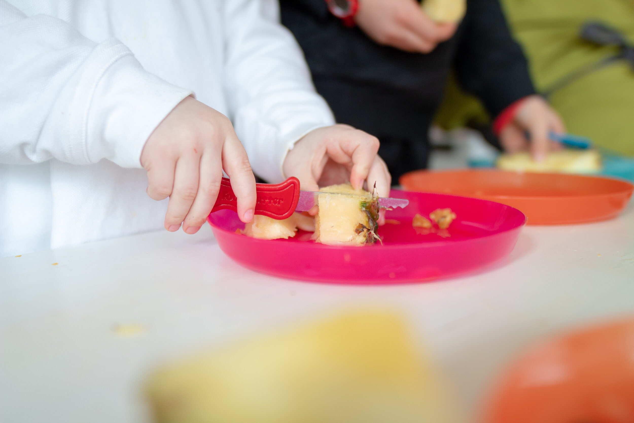 Deirdre Doyle from the Cool Food School Heathy birthday party cutting pineapple with a Kiddies Food Kutter.jpg