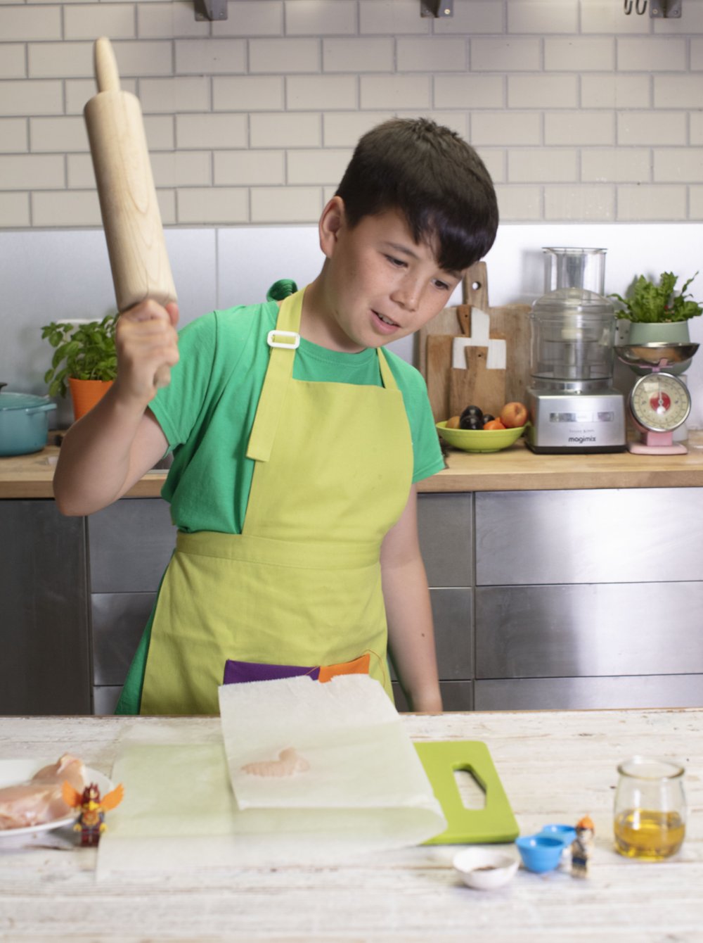 boy with apron preparing to bash the chicken