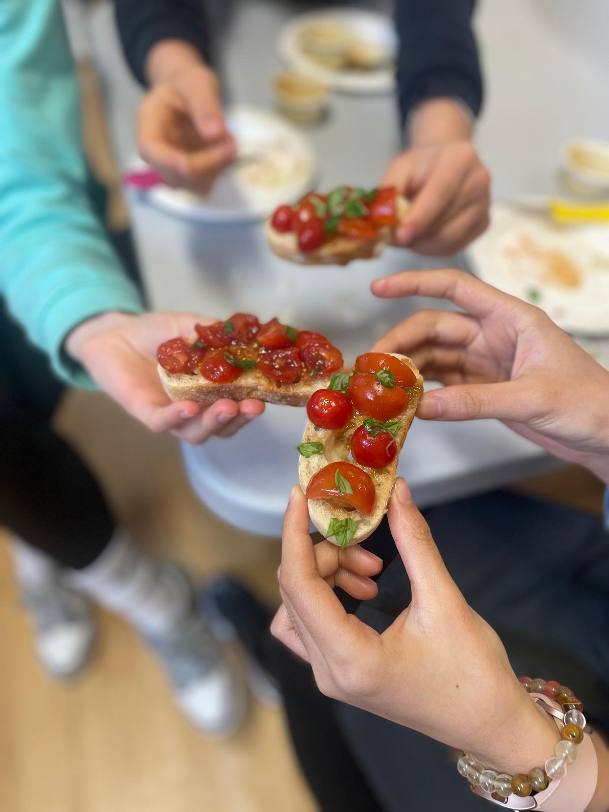 kids holding tomato bruschetta