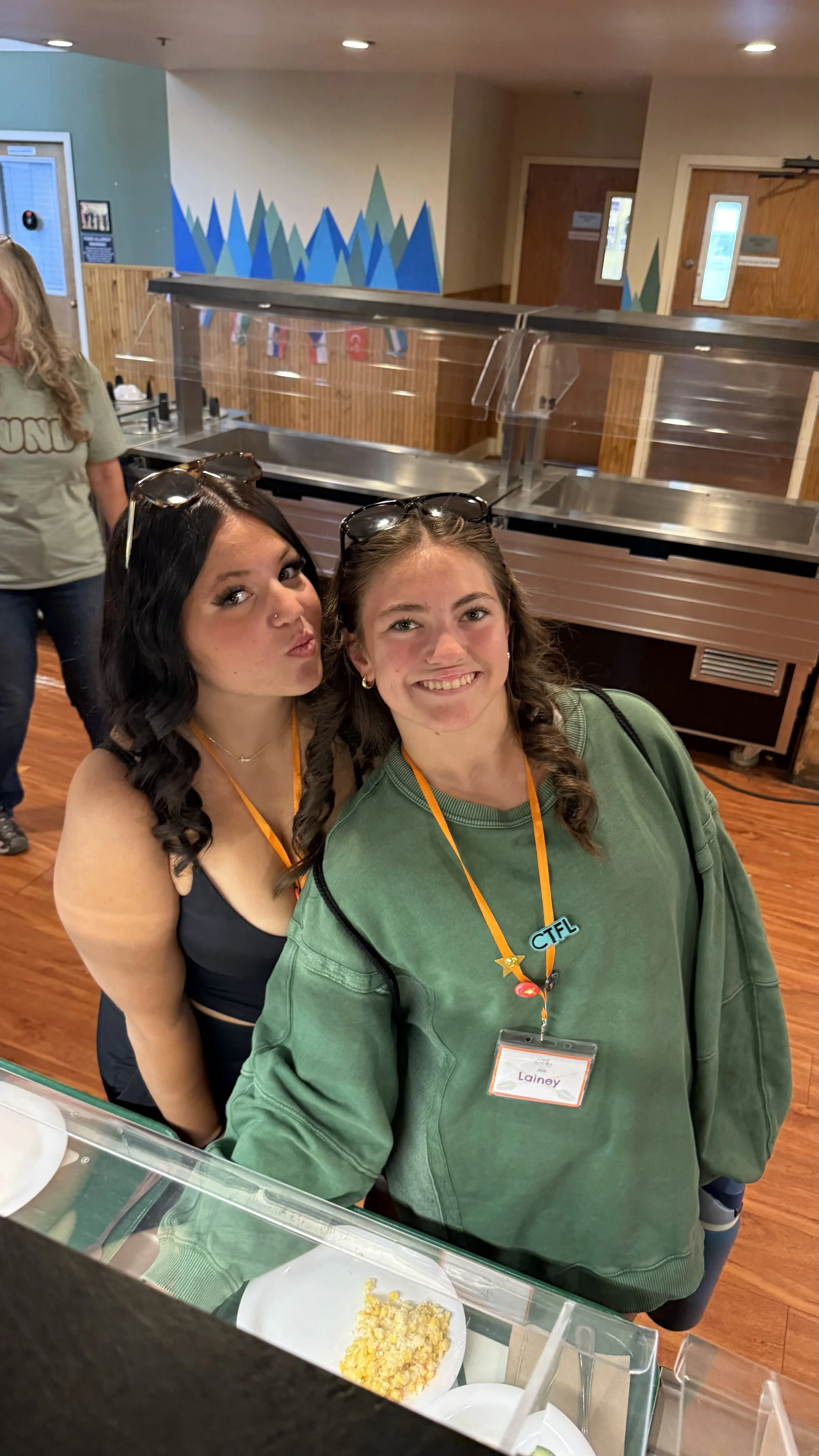 Two dance campers in a clean building at a salad bar for lunch