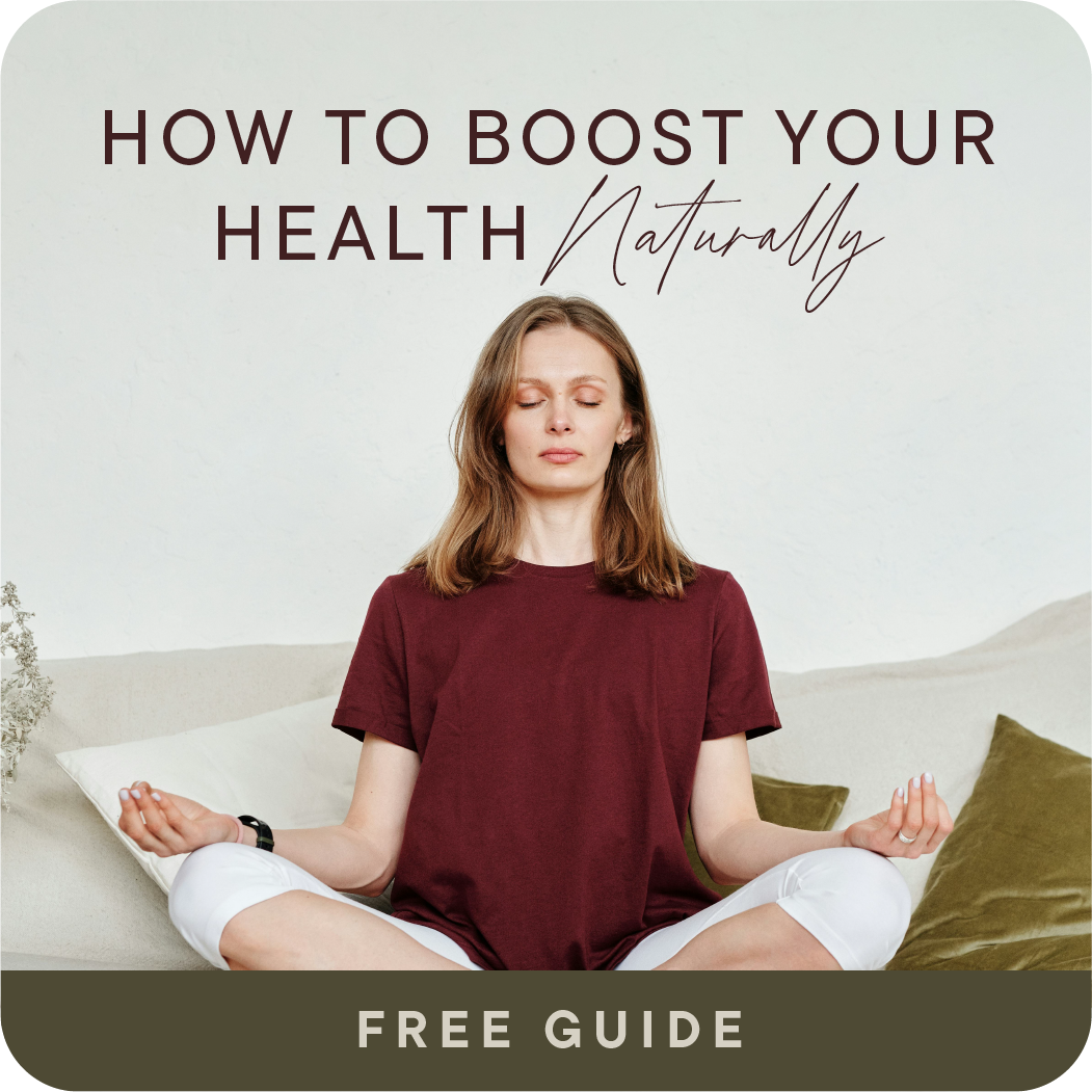 Woman meditating in a relaxed pose with eyes closed, sitting cross-legged on a sofa with pillows, promoting natural health and wellness.