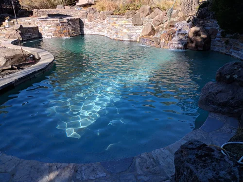 Custom pool with rockwork, water features and hillside construction