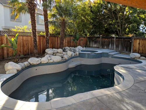 Completed swimming pool, raised spa, masonry and hardscape