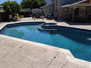 Completed custom swimming pool, spa and hardscape environment