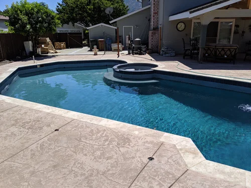 Decorative concrete pool deck and custom swimming pool