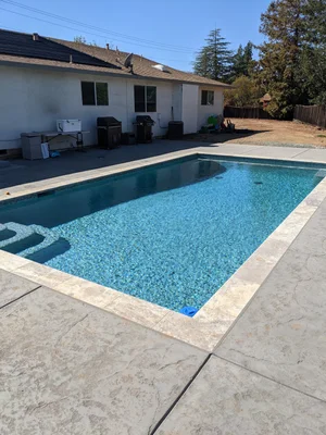 Completed backyard swimming pool project by Pacheco Landscape and Pool Construction