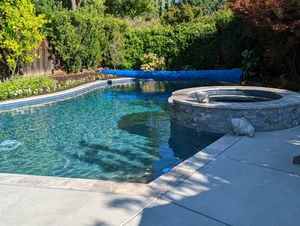 Completed pool coping, concrete deck and raised-spa masonry