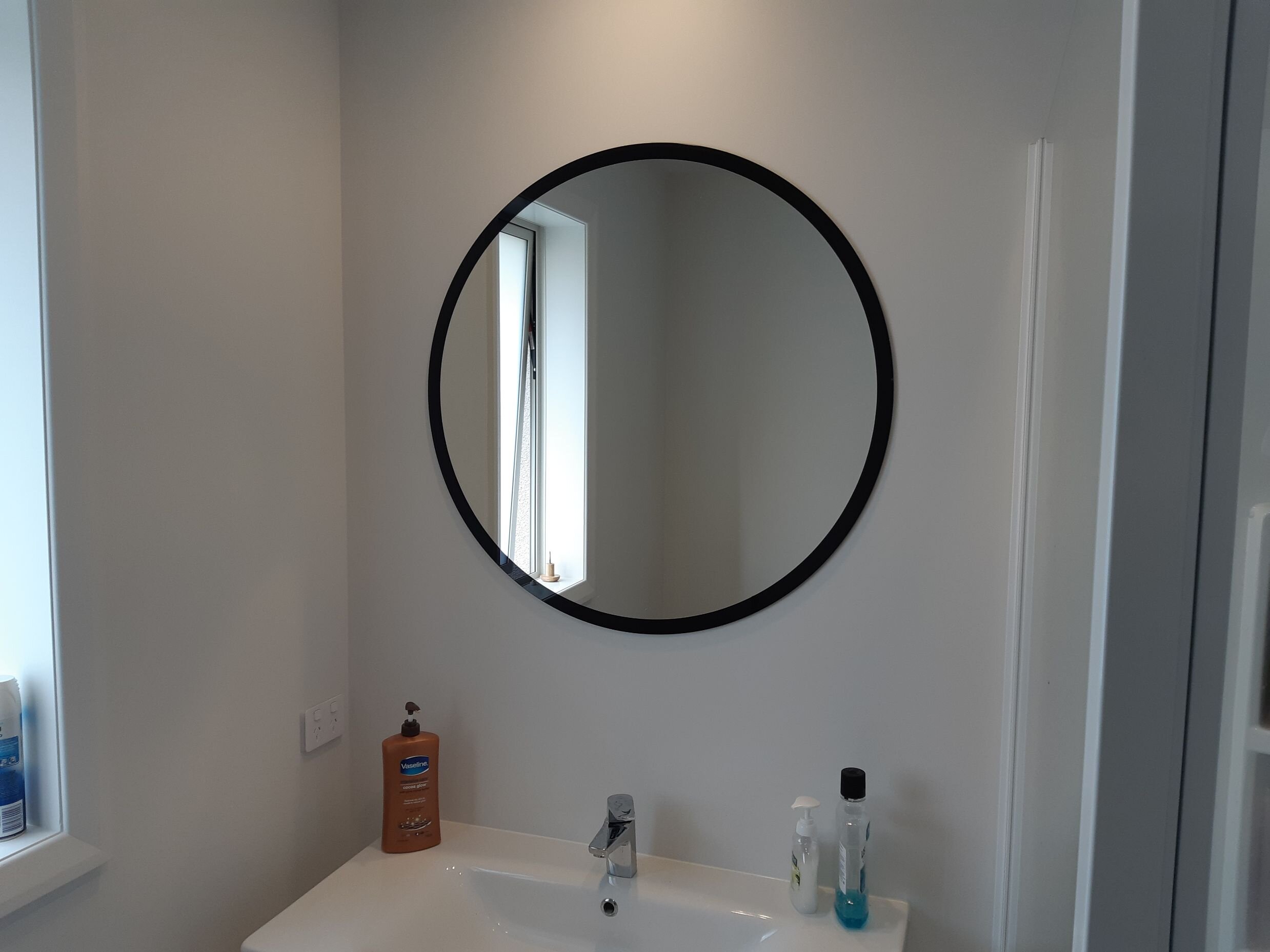 circular mirror black edging bathroom.jpg