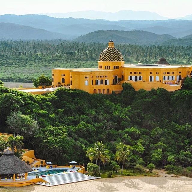 Cuixmala ✨ This 38 room hotel is perched high on a cliff above a private, two-mile beach, and has its own airstrip, meaning it is not exactly the kind of place you might just happen by. And, with its own tennis courts, football field, horse stables, 