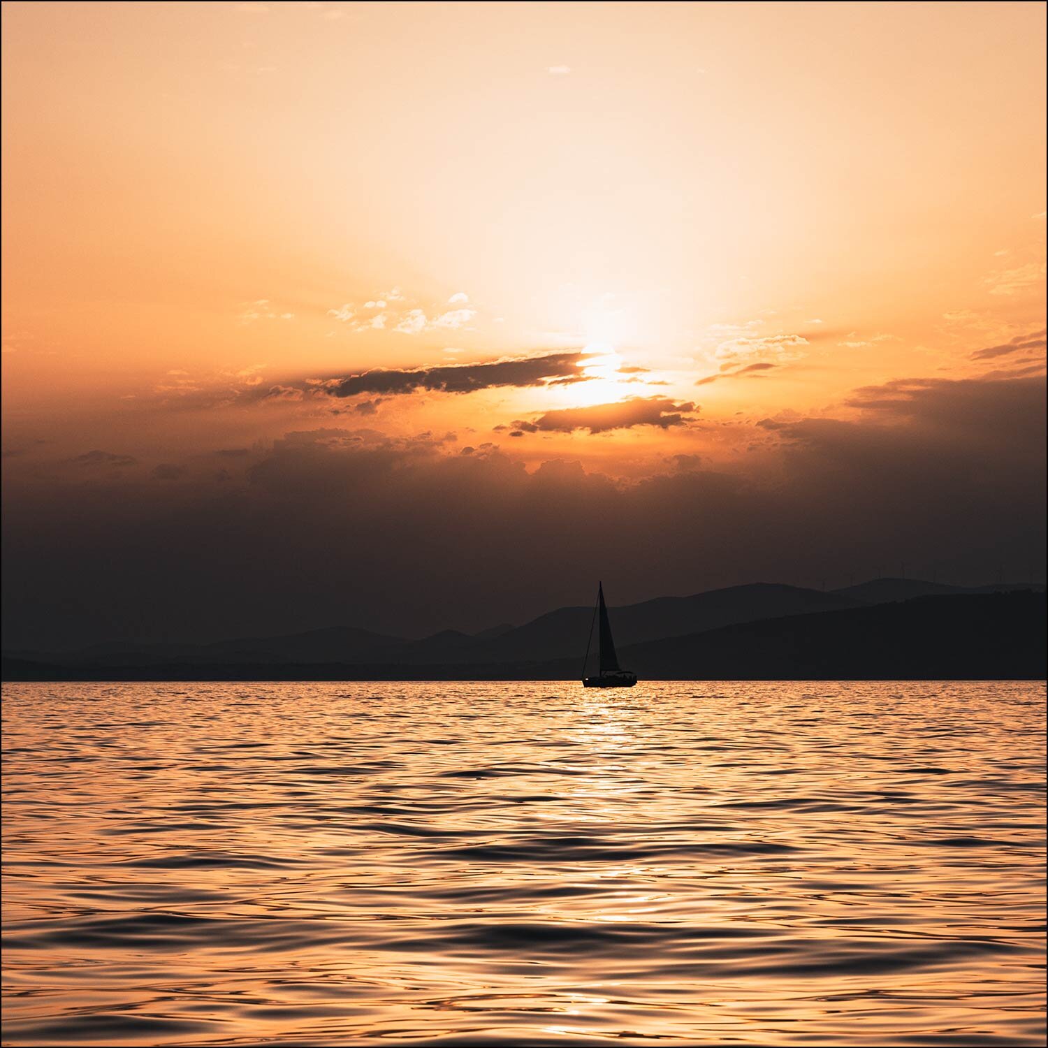 Boat sails into orange sky setting sun of coast of Split Croatia print section