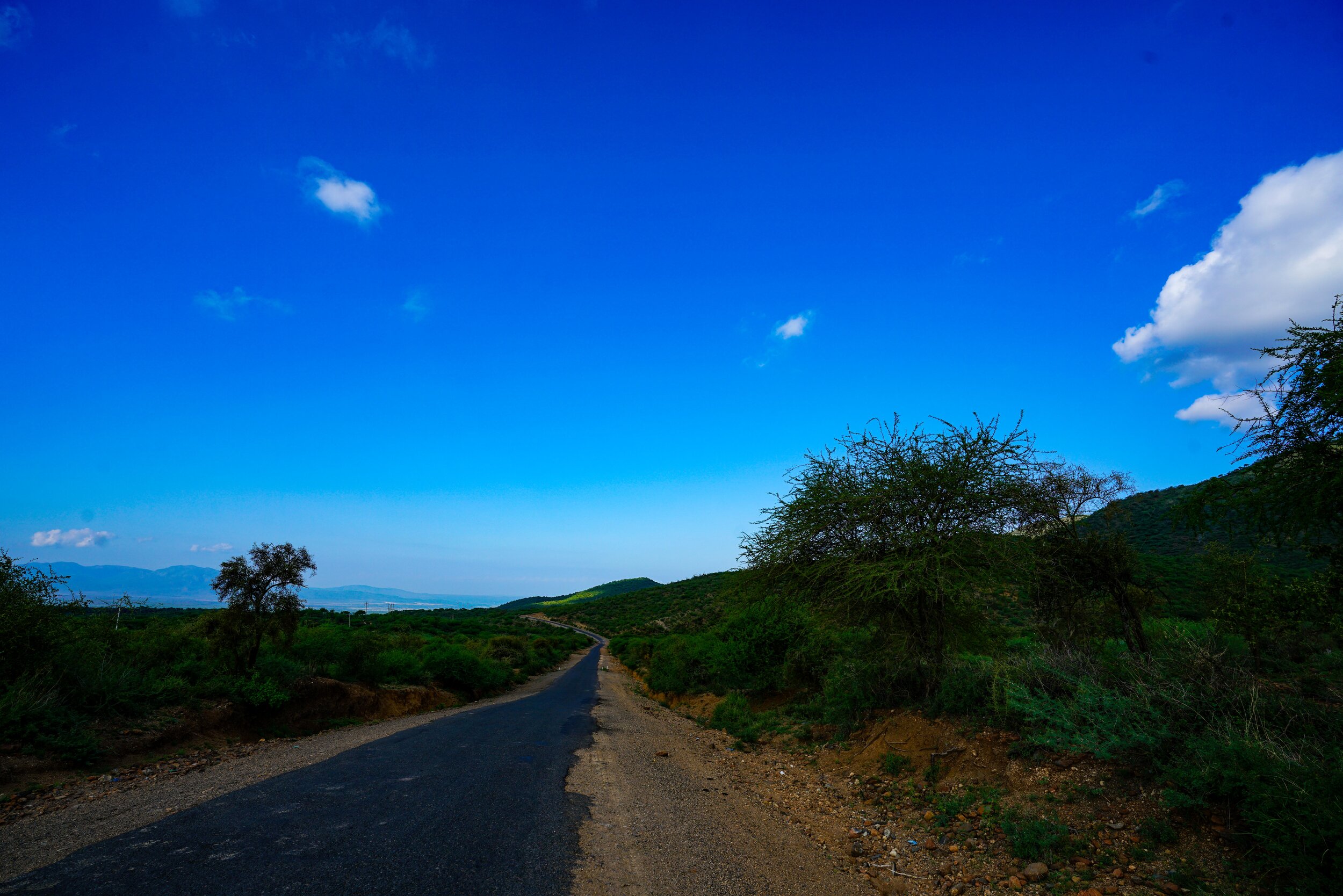  We waited an hour to be picked up by the Savage Tours team.  We stepped out from the sanctuary of the arrivals area into the Kenyan Air.  We boarded a mini bus.  Bus tour?  No.    We drove two hours to our first nights accommodation.  It’s an unimpr