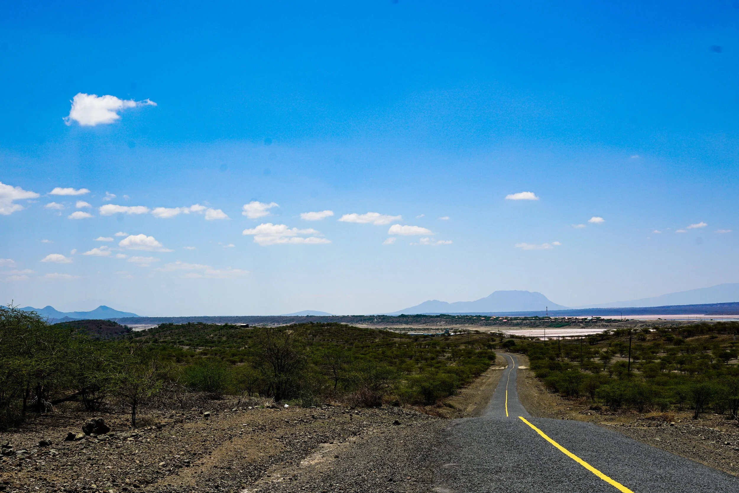  This is our first glimpses coasting down the hill to Magadi.    Unfortunately the headwind was so strong by this point that a significant amount of pedalling was required.   And, it was 44 degrees celsius.   It was a hard arrival.  And I took no pho