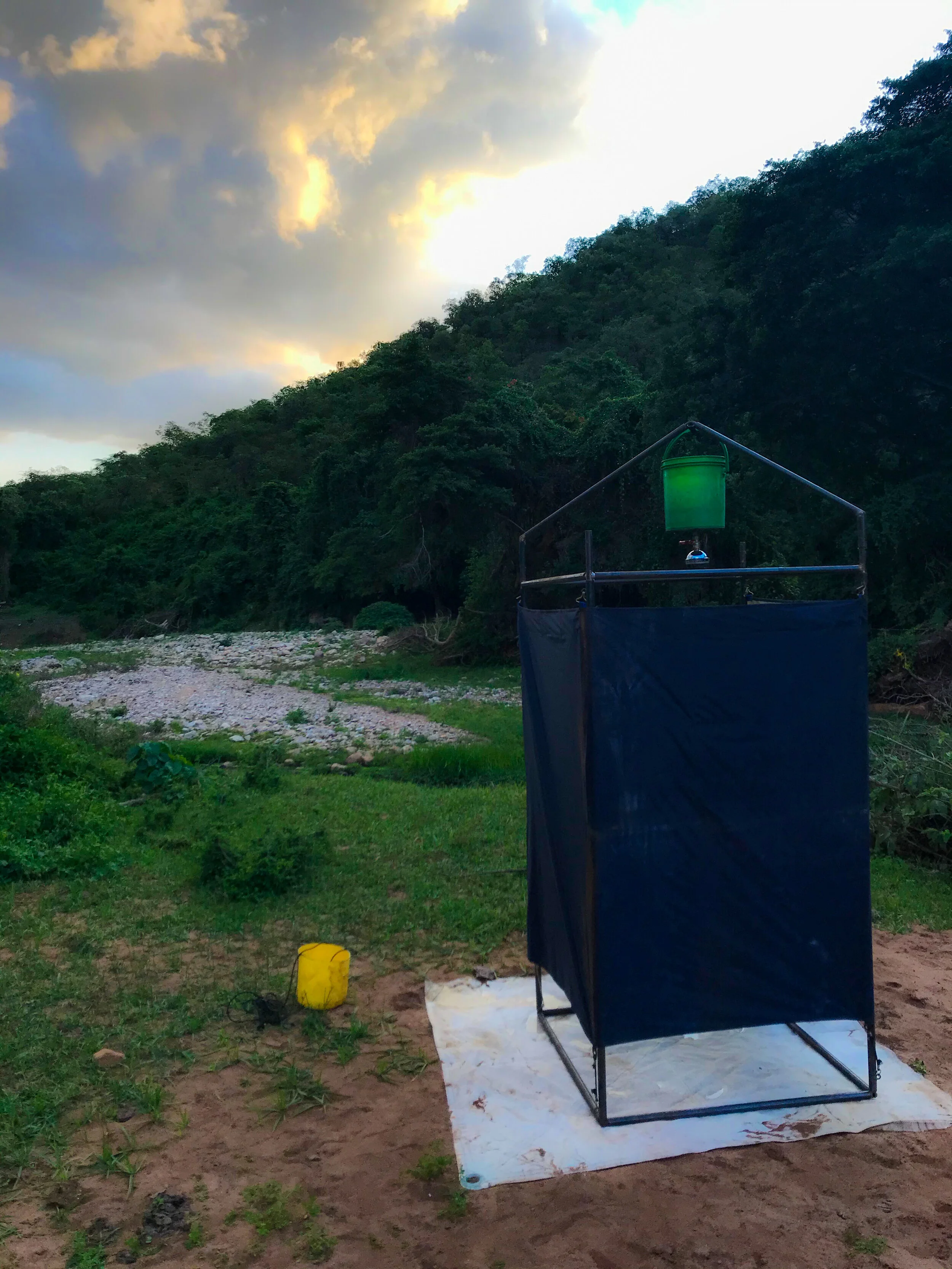  This is the river front shower which was unfolded from the back of the trucks.  It takes a few hours but my helpful guides finally hang a bucket of boiling water up on that tower for me.   