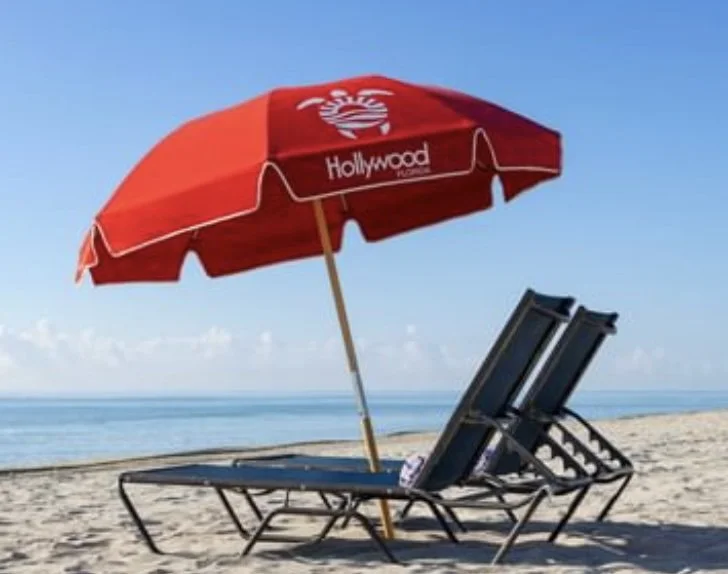 Red umbrella and blue lounge chairs.jpg