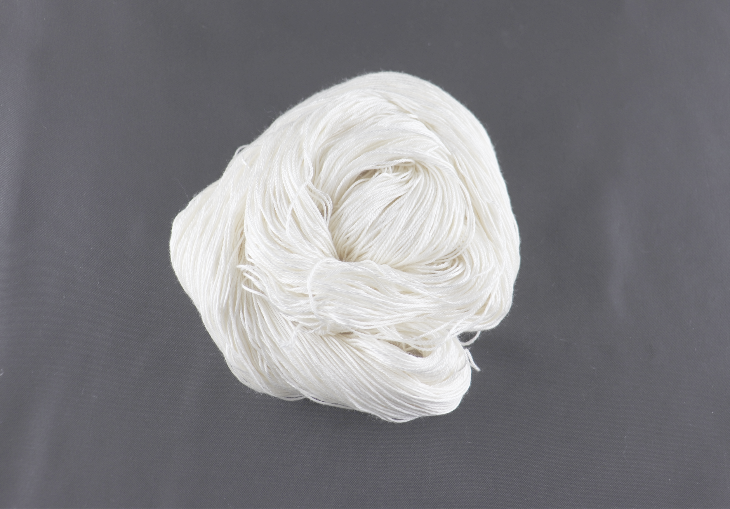 Luxe Silk Thick – 100% luxury mulberry silk. Bright white; very sleek and shiny, but just a tiny bit more texture than Swiss-milled silk (which has more of an ecru color). Fingering weight, 1960 ypp. 4 ply. Comes in 100g skeins. $90/lb.