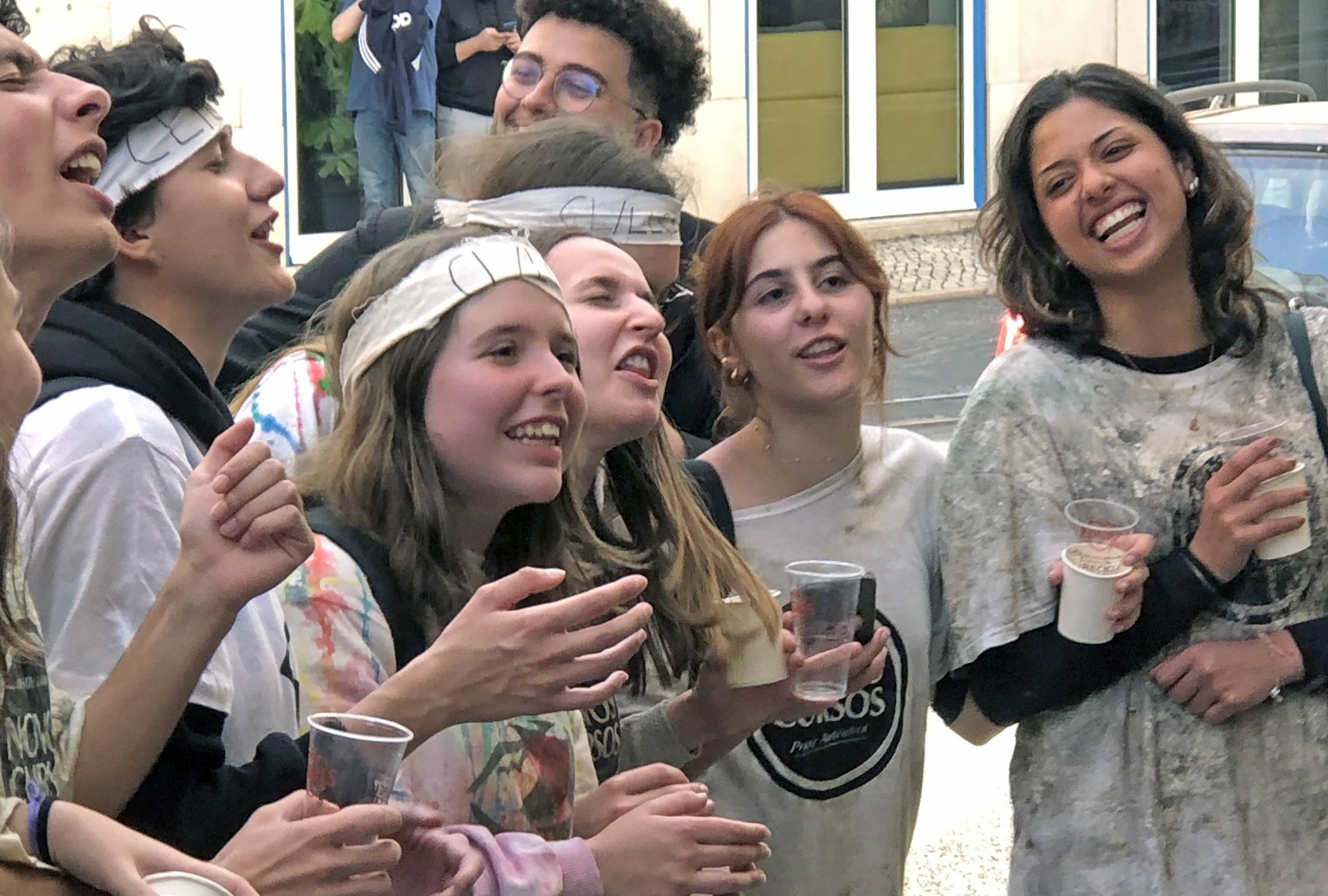 University of Lisbon freshmen singing on Lisbon streets as part of hazing ritual thrust upon them by sophomores. They seemed to enjoy the activity, so perhaps it was a fun form of hazing.